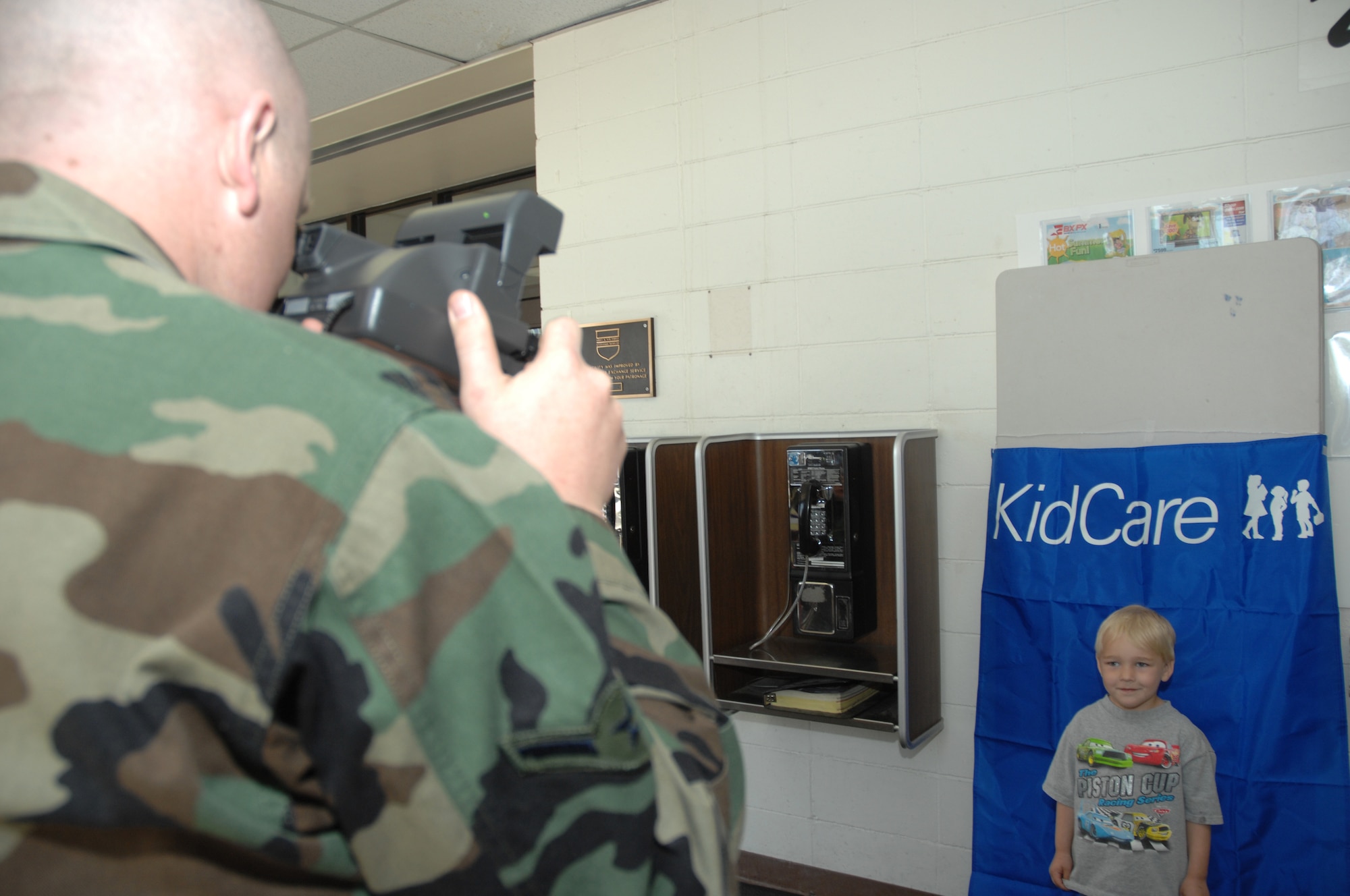 EIELSON AIR FORCE BASE, Alaska -- William Mason, son of Staff Sgt. Jack Mason, with the 354th Maintenance Squadron has photo taken by Airman Travis Hayes for a child identification kit during Police Week, May 19 at Eielson AFB, AK.  Police Week is an annual event hosted by the Security Forces Squadron in honor of National Police Week, among many of the activities occurring during the week is a program called Kid Care which is an identification kid which helps military and local authorities' assistance in locating missing children. (U.S. Air Force photo by Staff Sgt. Tia Schroeder)
