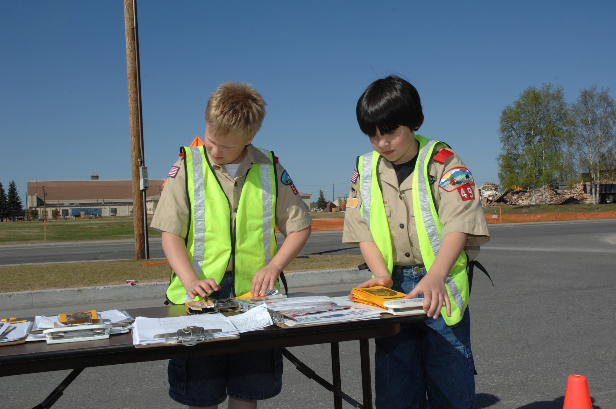 EIELSON AIR FORCE BASE, Alaska -- Bryan Hosea (left) and Cameron Cooper (right), Boy Scouts of America Troop 49, volunteer to hand out child safety seat informational brochures to parents during Police Week May 19, here at Eielson AFB, AK.  Police Week is an annual event hosted by the 354th Security Forces Squadron in honor of National Police Week. Among many of the activities during the week, 354th SFS makes sure parents are aware of the many dangers facing improper car-seat installation.  Traffic crashes are the leading cause of death and injury to children ages 0-15. (U.S. Air Force photo by Staff Sgt. Tia Schroeder)
