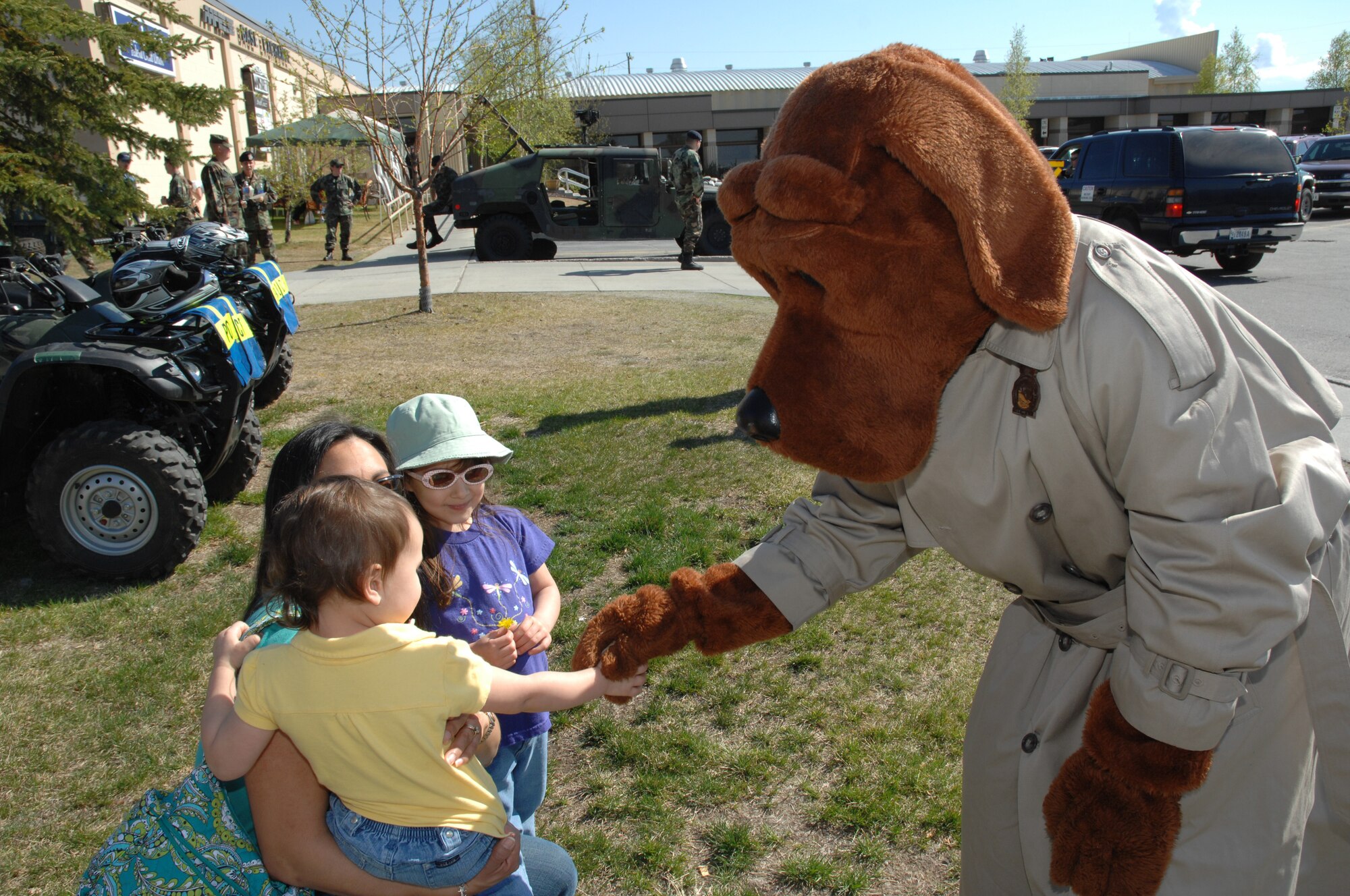 EIELSON AIR FORCE BASE, Alaska -- Jordan and Morgan Ossman, daughters of Capt. Derrick Ossman, 354th Security Forces Squadron, shakes hands with Officer McGruff, the Crime Dog during Police Week, May 19, here at Eielson AFB, AK. Police Week is an annual event hosted by the 354th SFS in honor of National Police Week. (U.S. Air Force photo by Staff Sgt. Tia Schroeder)
