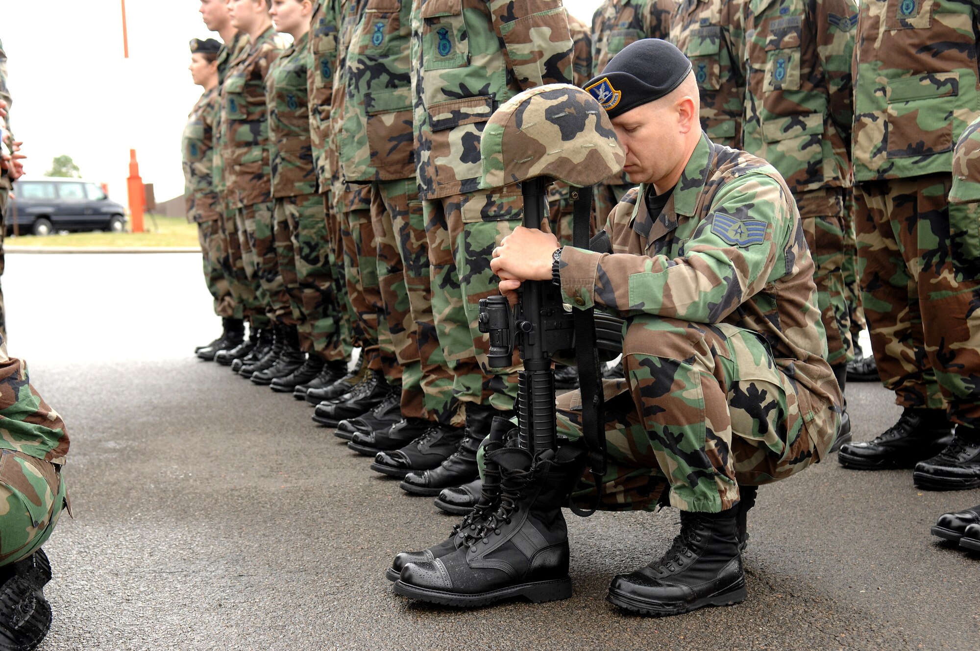 Staff Sgt. Robert Culbertson kneels in respect for a fellow airman during the Last Guard Mount ceremony May 16 at Ramstein Air Base, Germany. The Final Guard Mount Ceremony, which recognizes fallen security forces members, was held in conjunction with National Police Week. Sergeant Culbertson is a 435th Security Forces Squadron member. (U.S. Air Force photo/Senior Airman Levi Riendeau)
