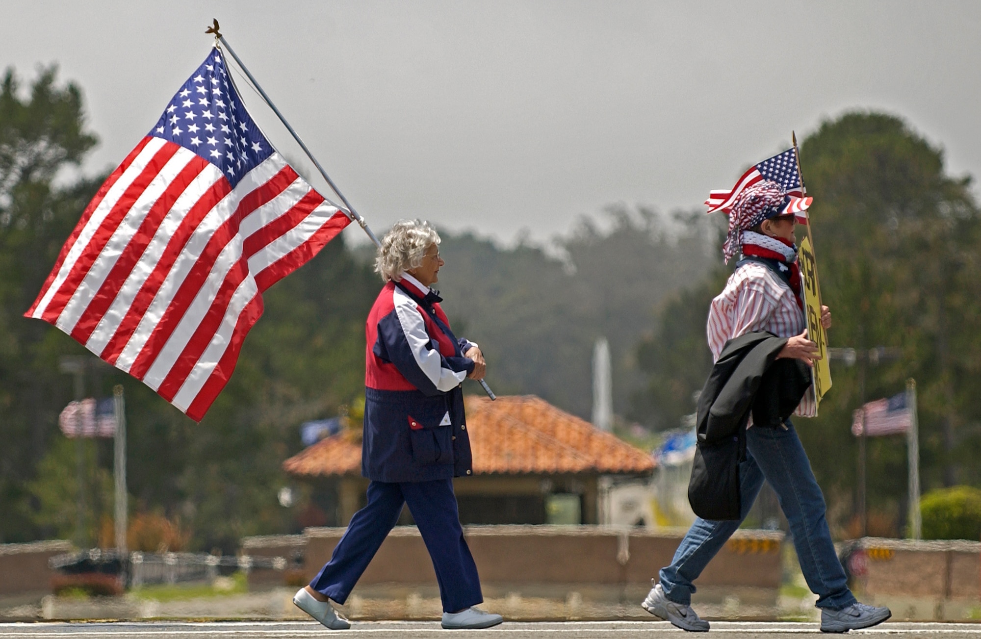 On Armed Forces Day, pro-troop demonstrators cross the road to congregate with others as a small group of anti-war protesters chant across the road from the Vandenberg Air Force Base entrance on May 19. About 20 people on each side turned out for the peaceful protest.  (U.S. Air Force Photo by Staff Sgt. Samuel Bendet)