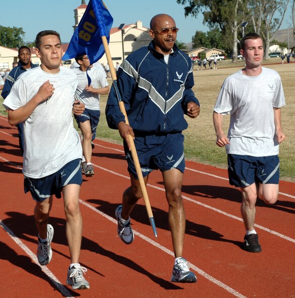Chief Master Sgt. Michael Williams, 60th Air Mobility Wing command chief, runs the homestretch to finish the 60th AMW Fun Run May 21. The run began and finished at the Fitness Center track and was part of Safety Focus Day. (U.S. Air Force photo by Staff Sgt. Candy Knight)