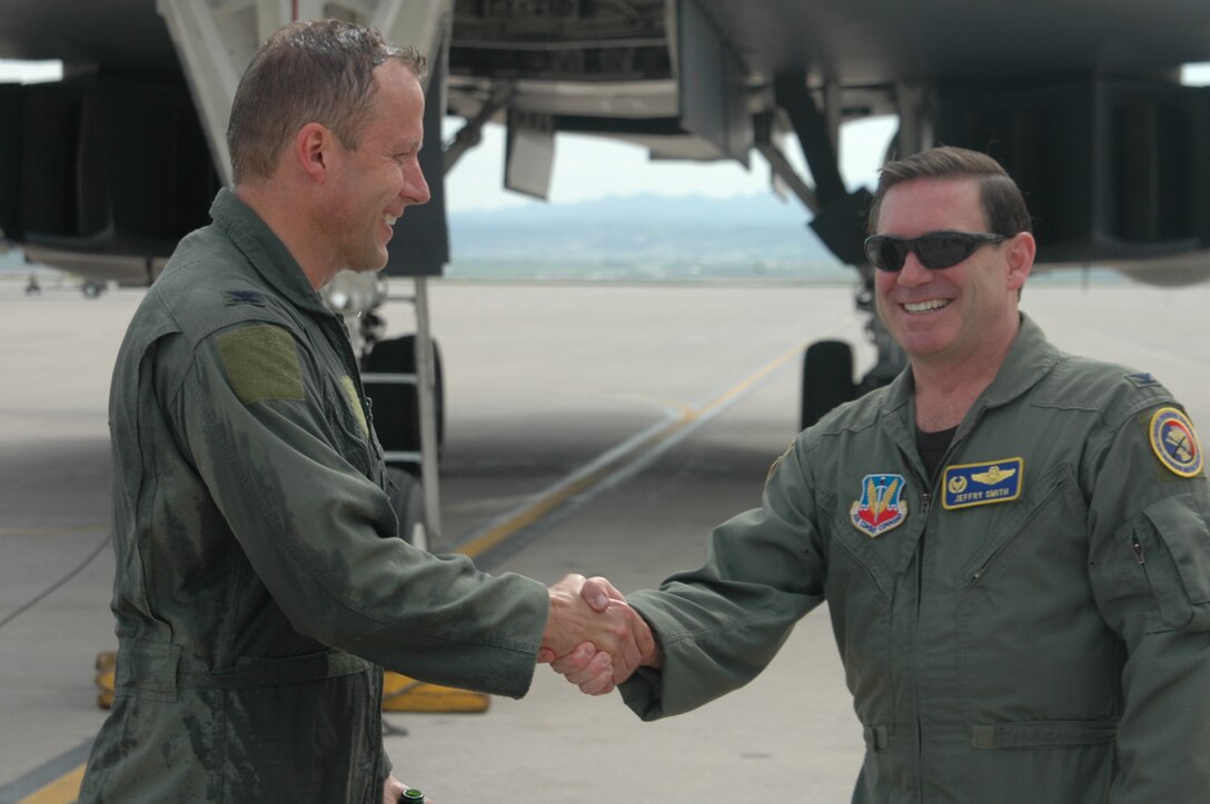 Col. Jeffry Smith, 28th Bomb Wing commander congratulates Col. Bruce Emig, 28th Bomb Wing vice commander, on the completion of his final B-1 flight, also known as "Fini-flight", May 11 here. Col. Emig will take over command of the 5th Bomb Wing, Minot Air Force Base, N.D. during a June 5 change of command ceremony . 