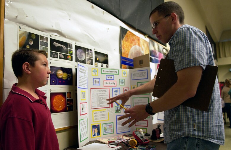 Fifth grader, Chris Kelly, 10, from La Honda Elementary School, answer questions to a judge about his science project "How electricity flows through circuits" during the annual Central Coast Science Fair at Maple High School on Vandenberg Air Force Base May 19.  The fair involved students from Lompoc Valley Middle School, Vandenberg Middle School, La Honda Elementary School and a student from Orcutt Junior High School. (U.S. Air Force Photo by Staff Sgt. Samuel Bendet) 