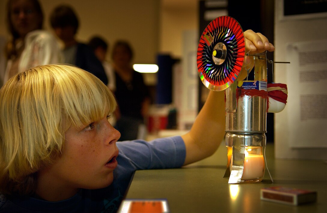 Seventh grader, Chris Naughton, 13, from Vandenberg Middle School, fine tunes his science project of the Stirling engine during the annual Central Coast Science Fair at Maple High School on Vandenberg Air Force Base May 19. The Stirling engine converts heat energy to mechanical energy.  (U.S. Air Force Photo by Staff Sgt. Samuel Bendet)