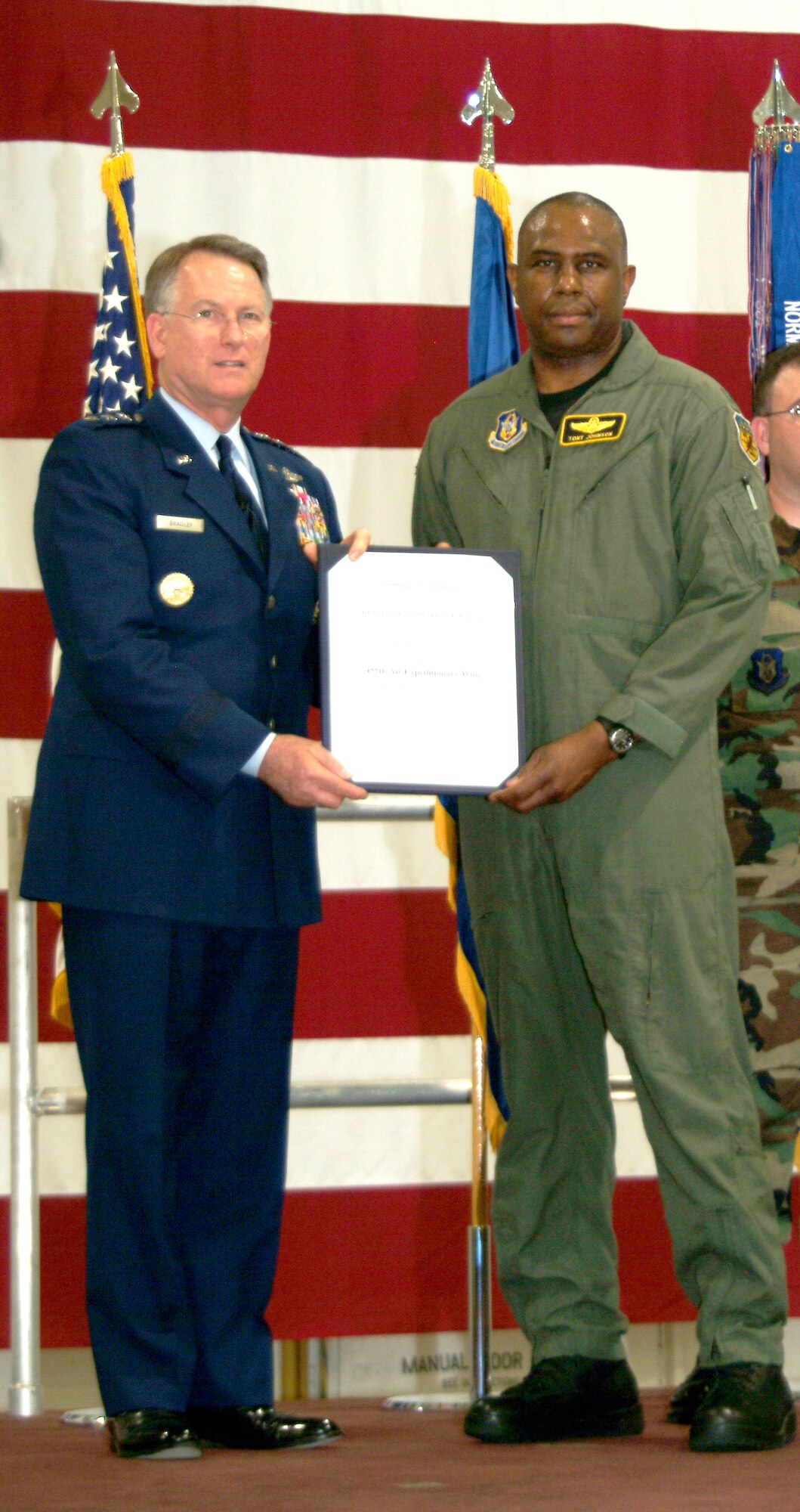 Lt. Gen. John A. Bradley, left, chief of the Air Force Reserve and commander of Air Force Reserve Command, presents a certificate for the Air Force Meritorious Unit Award to Col. Tony Johnson, then the commander of the 442nd Operations Group, May 5 at Whiteman Air Force Base, Mo.  Air Force reserervists from the 442nd were presented the award for their deployment to Afghanistan in the summer of 2006.  (U.S. Air Force photo/Master Sgt. William Huntington)