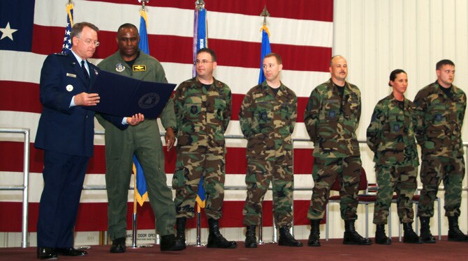Lt. Gen. John A. Bradley, chief of the Air Force Reserve and commander of Air Force Reserve Command presents a certificate for the Air Force Meritorious Unit Award to Col. Anthony Johnson at a ceremony May 5 for the 442nd Fighter Wing.  Six reservists from the 442nd were chosen to represent the more than 300 Citizen Airmen from the wing who earned the award while deployed to Bagram Airfield, Afghanistan in the summer of 2006.  The six were (left to right):  Colonel Johnson, then commander of the 442nd Operations Group; Maj. David Kurle, 442nd FW public affairs; Capt. David Casler, 303rd Fighter Squadron; Senior Master Sgt. Steve Smith, 442nd FW safety; and Tech. Sgt. Denise Brooks and Staff Sgt. Dustin Wright, both from the 442nd Maintenance Group.  (U.S. Air Force photo/Master Sgt. William Huntington)