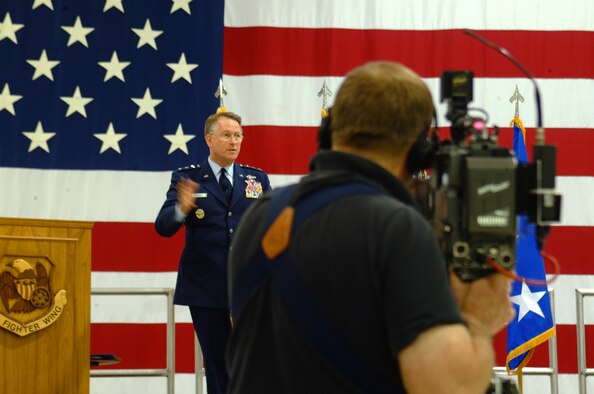 A television cameraman takes aim at Lt. Gen. John A. Bradley, chief of the Air Force Reserve and commander of Air Force Reserve Command, during his remarks to reservists in the 442nd Fighter Wing May 5.  General Bradley presented the Air Force Meritorious Unit Award to more than 300 members of the wing who deployed to Afghanistan during the summer of 2006.  (U.S. Air Force photo/Master Sgt. Christina Suratos)