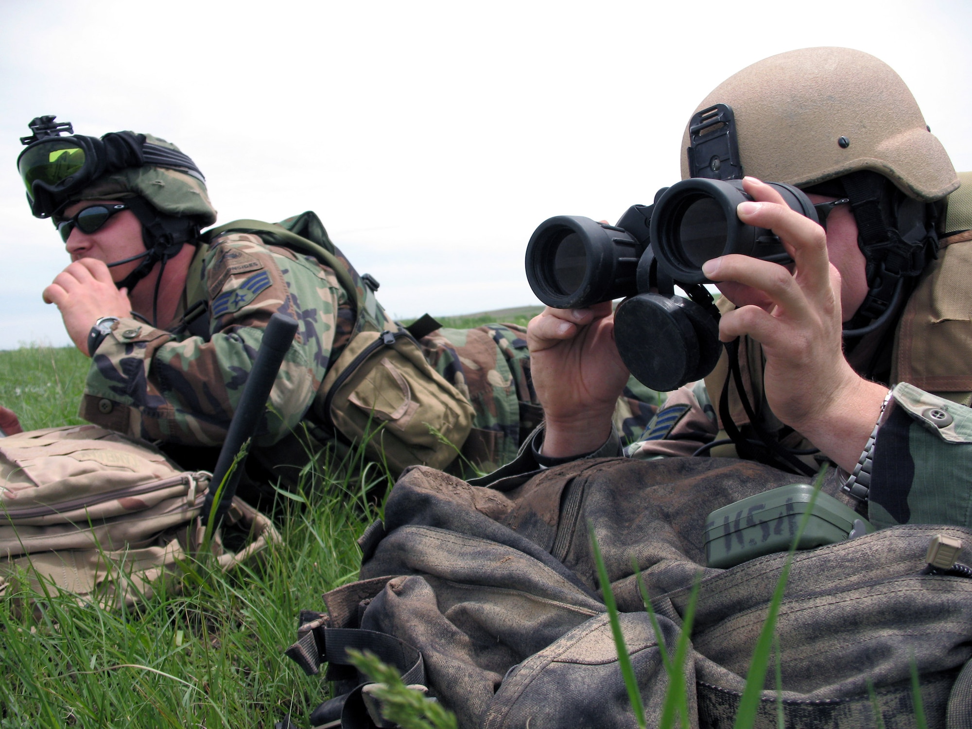 Senior Airman Rusty Welch (left) talks to A-10 Thunderbolt II pilots overhead as Staff Sgt. Josh Carter looks at targets on the Smoky Hill Air National Guard Range, Kan. The joint terminal attack controllers were at the range training for deployments to Iraq and Afghanistan. There they work alongside the Army and Marines providing air power to troops on the ground. (U.S. Air Force photo/Staff Sgt. Leigh Bellinger) 
