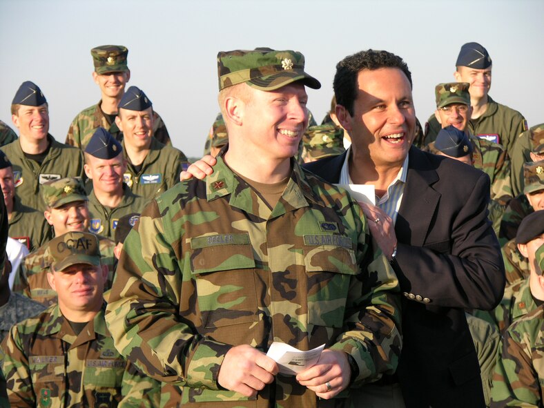 MAXWELL AIR FORCE BASE, Ala. -- Maj. Vic Beeler, a student at Air University's Air Command and Staff College, enjoys a light moment with Fox and Friends' co-anchor Brian Kilmeade, alongside the base's Officer Training School track at Maxwell Air Force Base, Ala., May 18.  Major Beeler, along with other ACSC officers and enlisted troops at Air University helped Mr. Kilmeade read the morning's sports stories, as Mr. Kilmeade broadcast live during the Fox network cable morning show.  Mr. Kilmeade was broadcasting from Maxwell as part of Fox' Salute to the Military at various Air Force installations. (U.S. Air Force photo by Carl Bergquist)