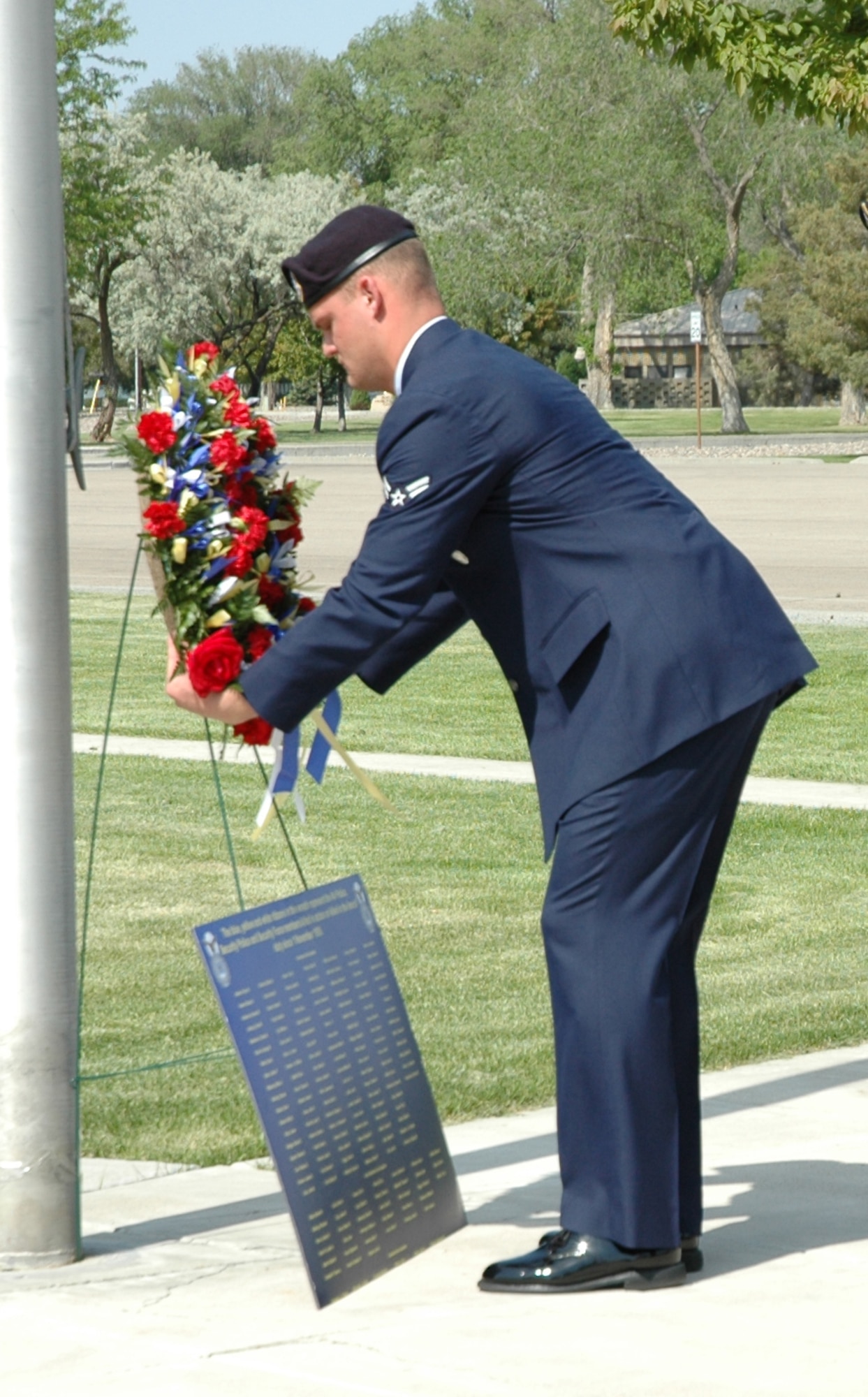 MOUNTAIN HOME AIR FORCE BASE, Idaho -- Airman 1st Class Cole Cournyer, 366th Security Forces Squadron, places a wreath on a memorial honoring fallen police officers at a formal retreat ceremony at Holt Park here May 18. The ceremony concluded the base's National Police Week observance. (U.S. Air Force photo/Airman Samantha S. DeVries)
