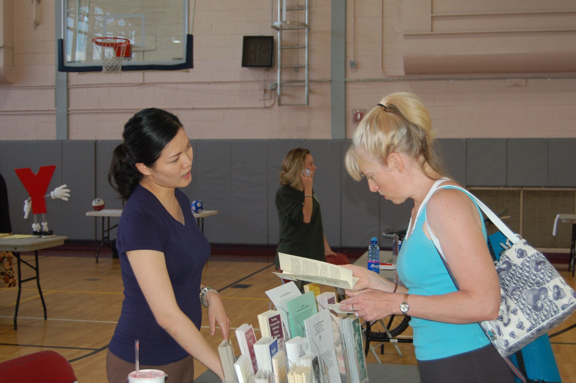 Stacy Skaggs (right), a yoga teacher at the fitness center, talks to Debbie Hsico Ki Ting of Tai Ji Chinese Medicine and Acupuncture. Hundreds of servicemembers and civilians came out for the fitness center’s seventh annual Health and Wellness Fair May 18, which featured health exhibitors from the Colorado Springs area. (U.S. Air Force photo by Corey Dahl)