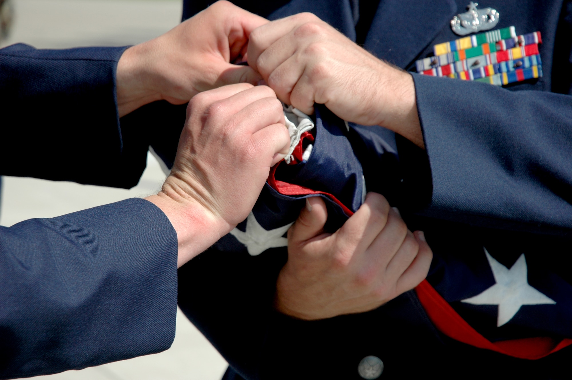 MOUNTAIN HOME AIR FORCE BASE, Idaho -- Staff Sgt. Richard Saltkill and Senior Airman Chase Hoffman, both from the 366th Security Forces Squadron here, fold the colors during a formal retreat ceremony at Holt Park here May 18. The ceremony concluded the base's National Police Week observance. (U.S. Air Force photo/ Airman Samantha S. DeVries)