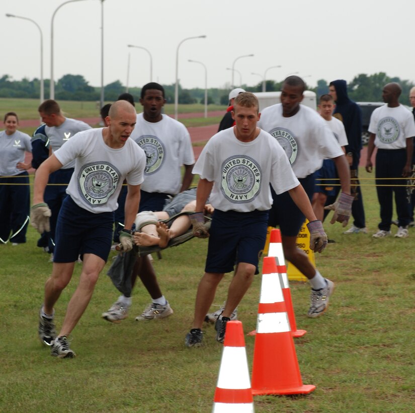 Members of the Navy Seabee B team rush their "injured" person to the finish line in the litter carry event at the Joint Warrior Challenge May 19. (U.S. Air Force photo/Airman 1st Class Jacob Corbin)