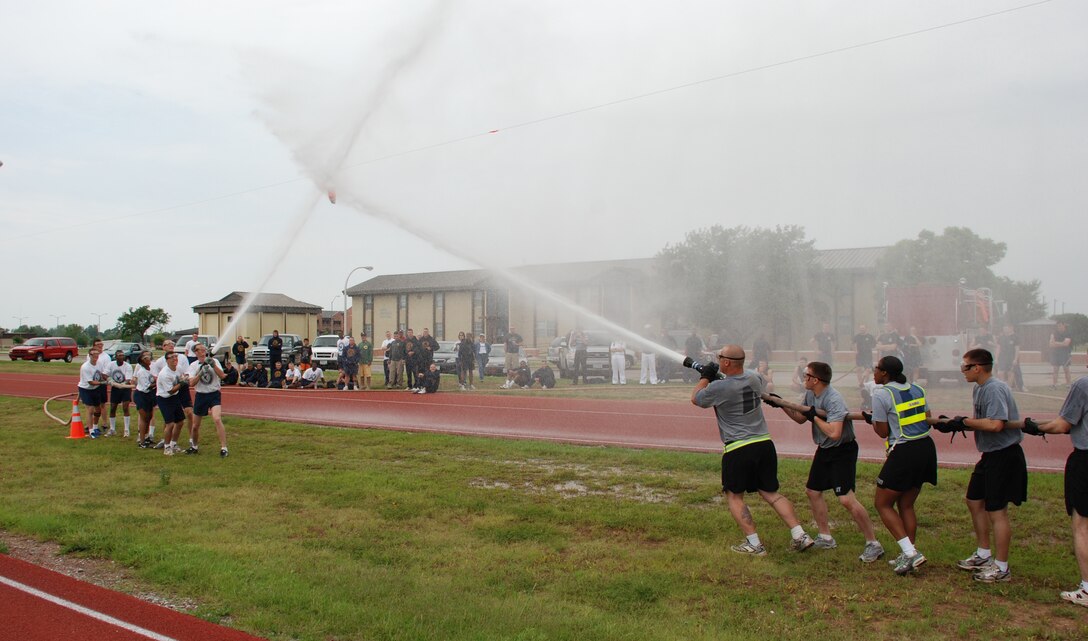 Members of the Army and Navy teams face off during the fireman's hose tug-of-war at the Joint Warrior Challenge May 19. (U.S. Air Force photo/Airman 1st Class Jacob Corbin)