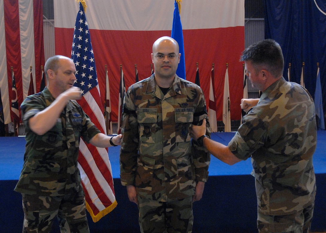 Airman 1st Class David Sosa, 31st Aircraft Maintenance Squadron, is promoted by 
Col. Monty Brock, 31st Fighter Wing vice commander, during Aviano’s monthly promotion ceremony at Hangar One April 30. Photo by Airman 1st Class Liliana Moreno
