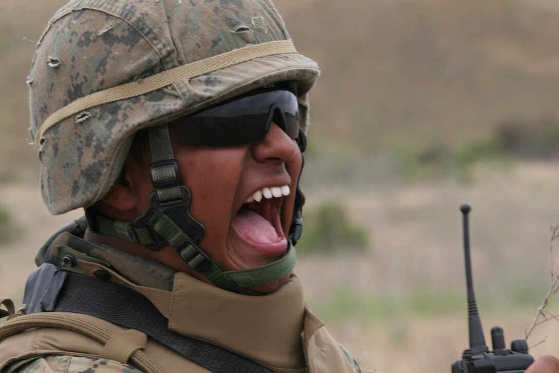 MARINE CORPS BASE CAMP PENDLETON, Calif.(May 22, 2007)?Cpl. Jose L. Aguilar, a Buena Park, Ca. native, screams, ?Shift left!? as his squad conducts support by fire for an advancing assault element. Marines from Company B, Battalion Landing Team 1st Battalion, 5th Marine Regiment, 11th Marine Expeditionary Unit conducted mechanized raids on numerous simulated enemy positions May 21-25.  Aguilar is 3rd Squad leader, 1st Platoon.