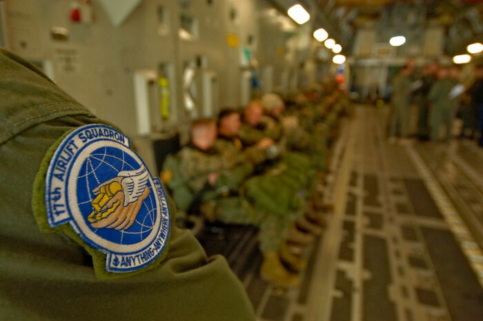 Airman 1st Class Kevin Kehoe, 17th Airlift Squadron loadmaster, assists 20 Marines based out of Camp Lejeune, N.C., with their preparation to jump out of a Charleston AFB C-17 at 2,000 feet May 18.  (U.S. Air Force photo/Staff Sgt. April Quintanilla)