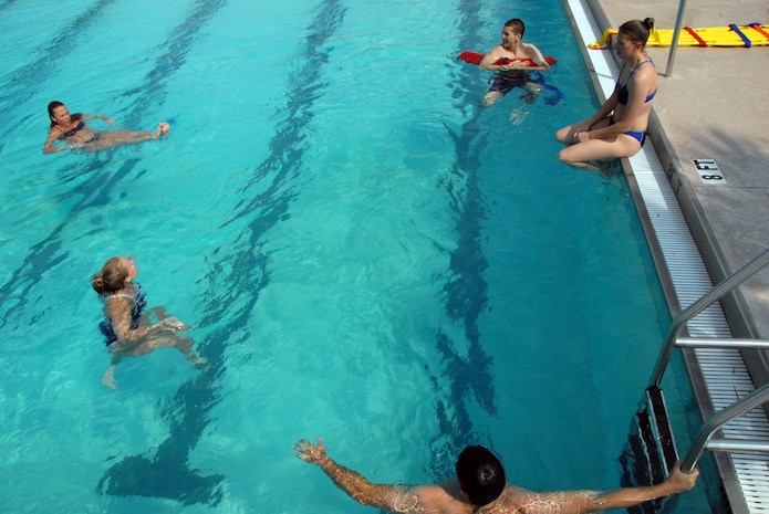 Base pool lifeguards meet every two weeks to practice life-saving skills at the pool. The base pool is scheduled to open Saturday. (U.S. Air Force photo/Senior Airman Sam Hymas)
