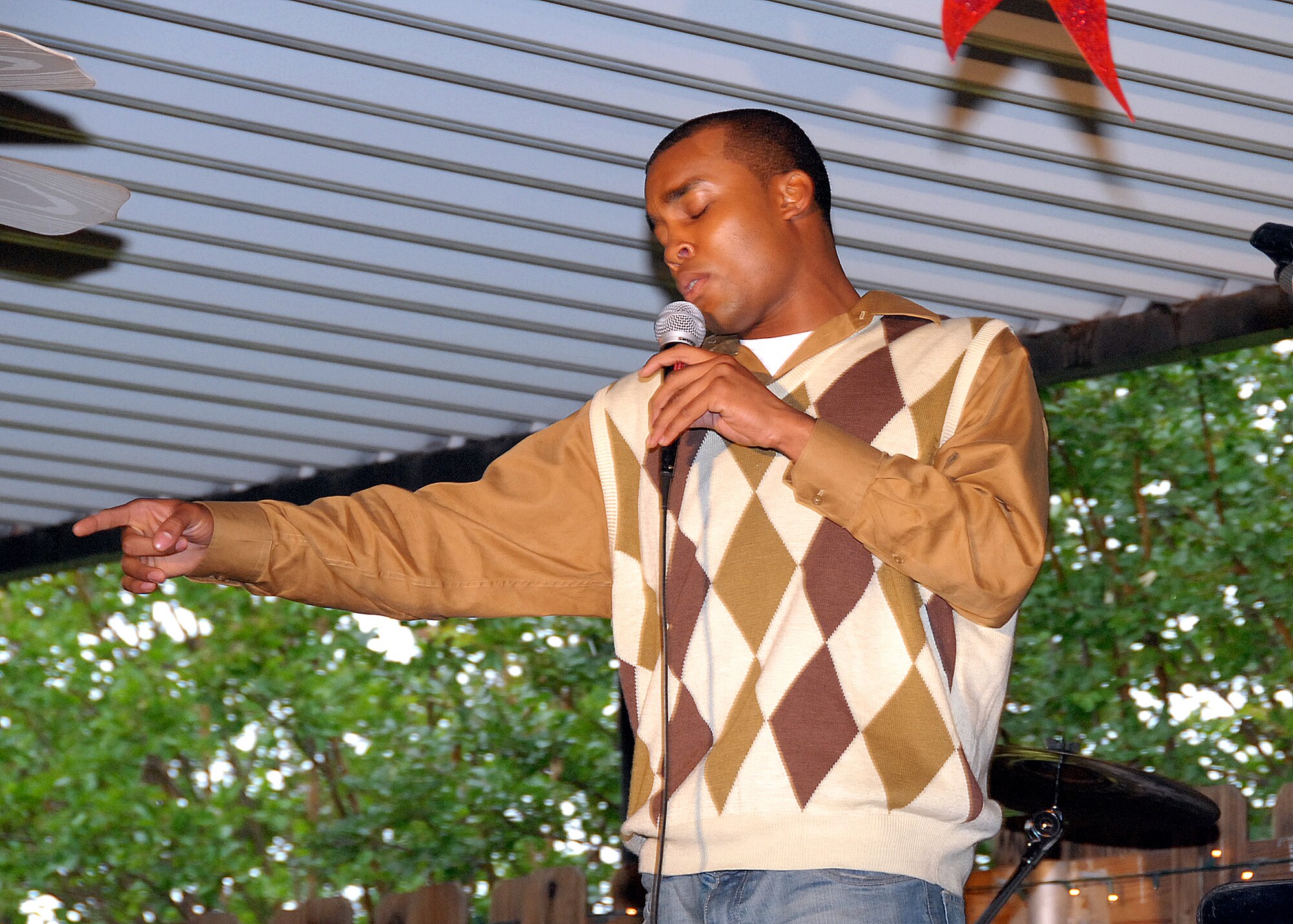 Army Private 1st Class Christopher Norwood of the 264th Medical Batallion performs as one of the five finalists in the Sheppard Idol competition at the Sheppard Club May 18. (U.S. Air Force photo/Mike Litteken)