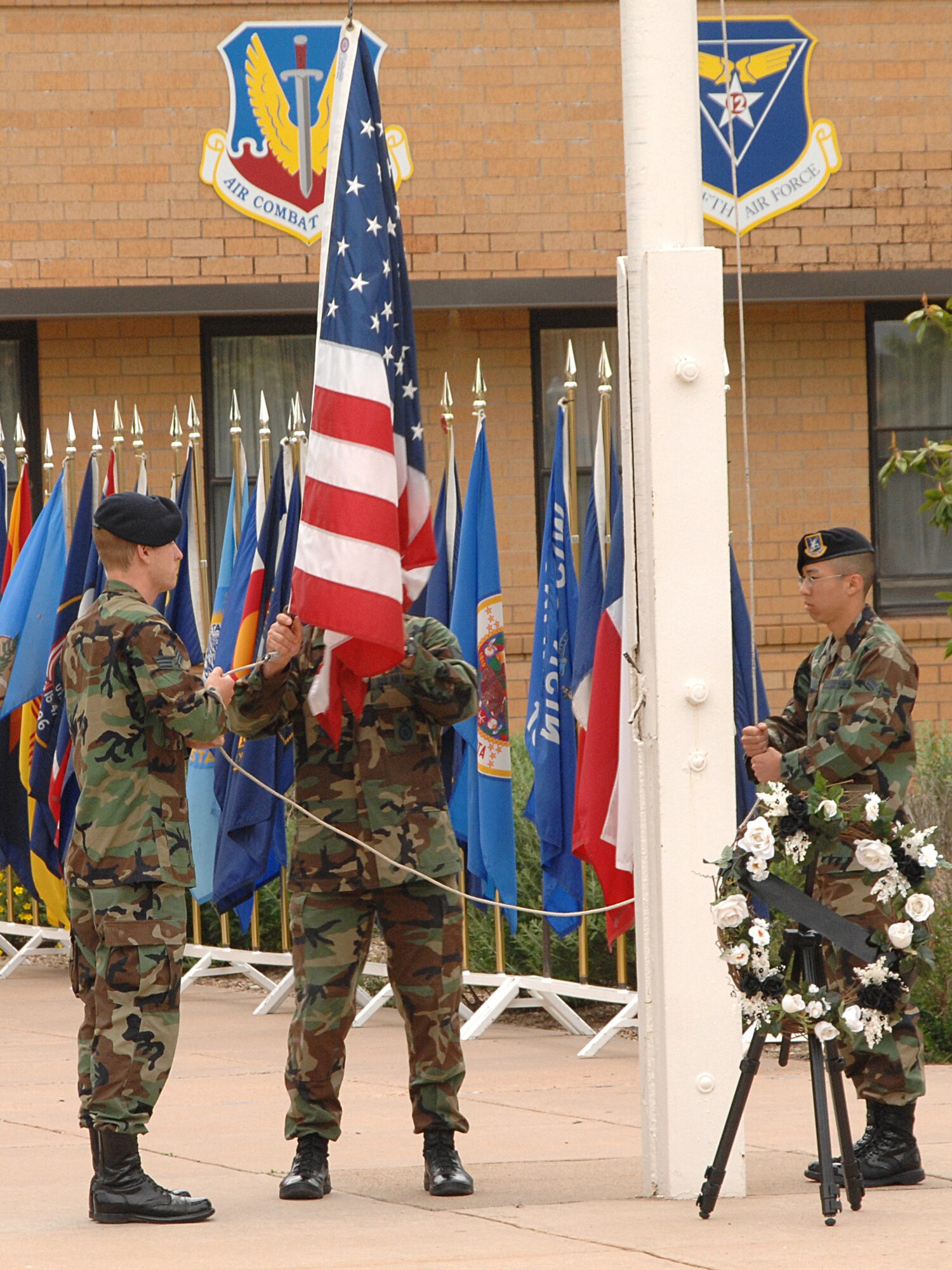 27th Security Forces Squadron Airmen lower the flag May 18 in memory of all fallen law enforcement officers at a retreat ceremony during National Police Week May 13-19. (U.S. Air Force photo by Senior Airman Heather Redman)