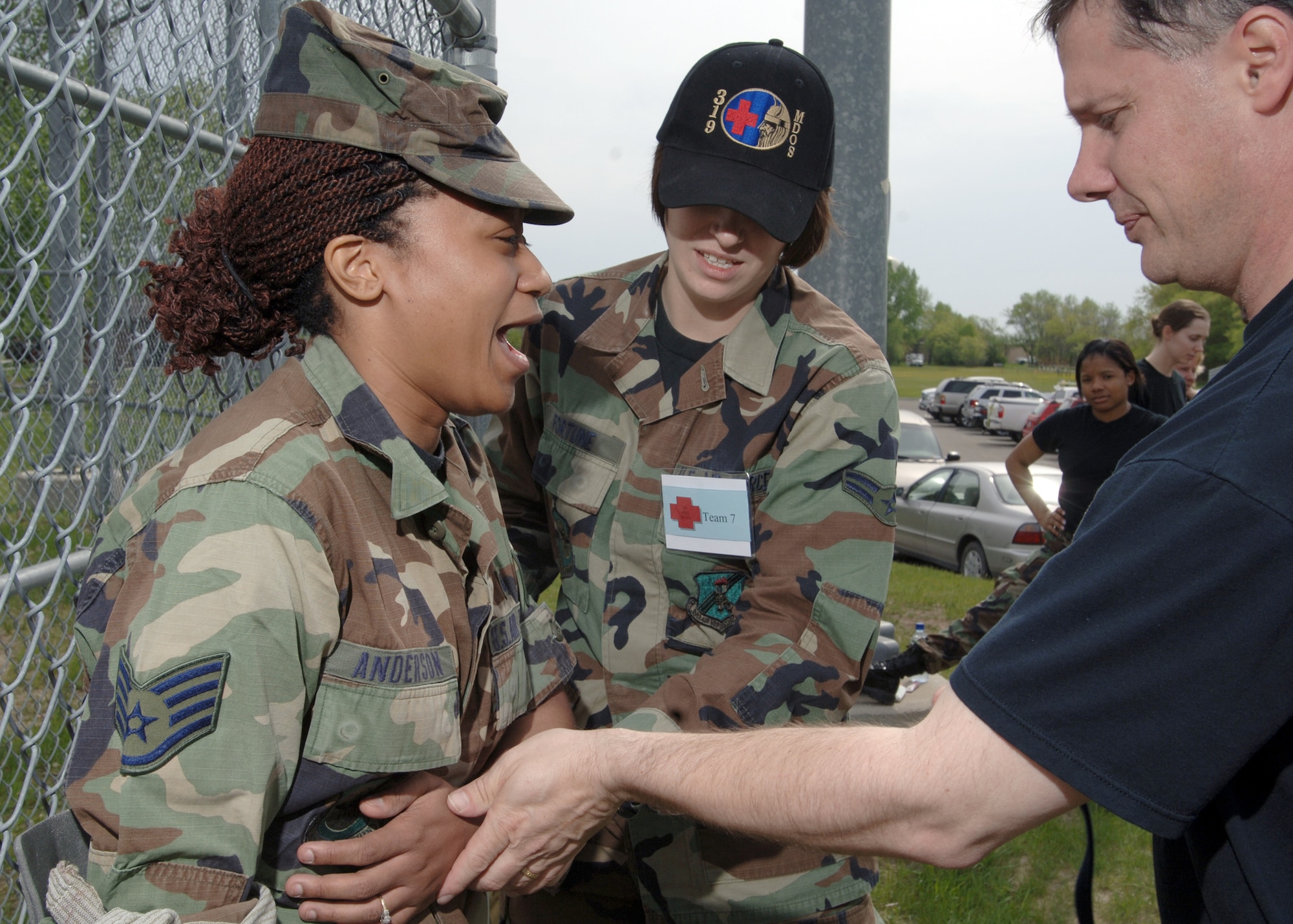 Lt. Col. Randall Nedegaard and Airman 1st Class Jessica Fortune, 319th Medical Group, care for Staff Sgt. Shaleika Anderson’s arm during the Med Group Rodeo here May 18. The competition gave medical personnel from many backgrounds the opportunity to put their skills to the test. (U.S. Air Force photo/Staff Sgt. Suellyn Nuckolls)