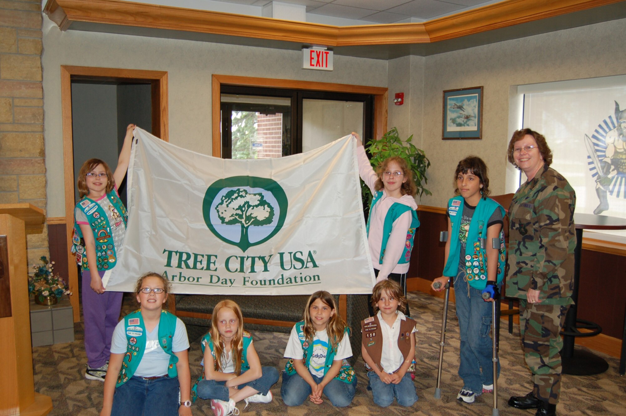 Grand Forks Air Force base was presented with the Tree City USA for North Dakota from the Arbor Day Foundation during a ceremony May 22. Local groups such as the Girl Scouts volunteer to plant trees keeping the base part of Tree City USA each year. (U.S. Air Force photo/Airman 1st Class Ashley Coomes)