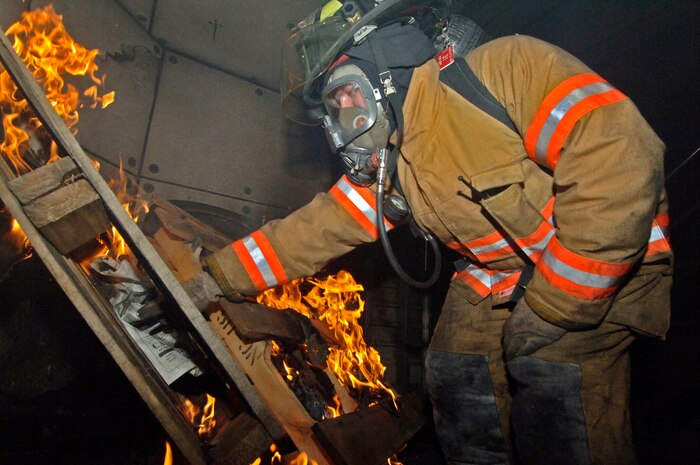 Tech. Sgt. John Hearn, 437th Civil Engineer Squadron firefighter, ignites a fire for a training exercise May 23 at the Charleston AFB fire department training facility. (U.S. Air Force photo/Staff Sgt. April Quintanilla)