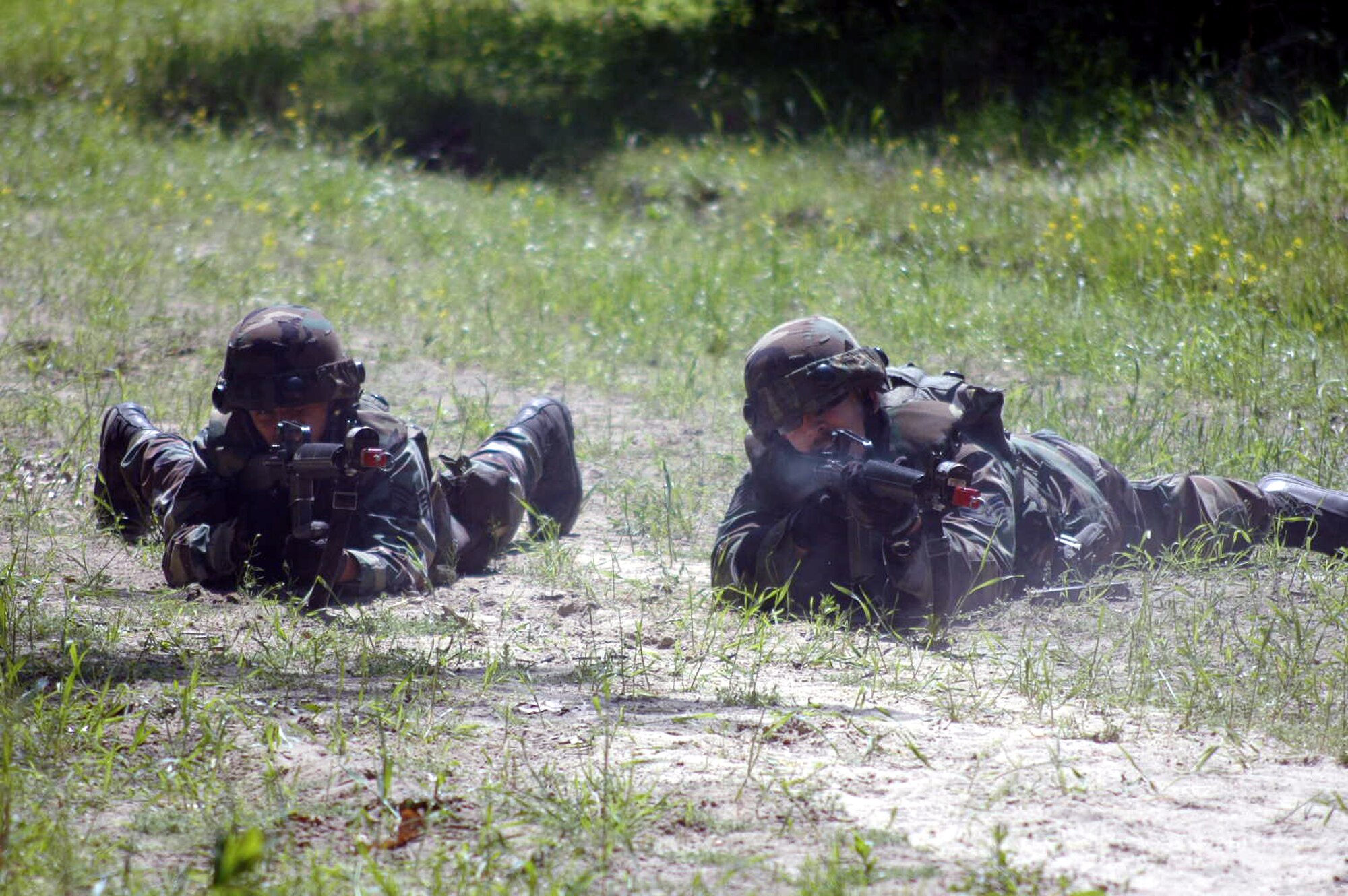 U.S. Air Force Airmen respond to a scenario during a patrolling and tactics class for the Air Force Advanced Contingency Skills Training Course 07-2C May 14, 2007, at Fort Dix, N.J.  The course, taught by the U.S. Air Force Expeditionary Center's 421st Combat Training Squadron, prepares Airmen for upcoming deployments in a variety of combat skills.  (U.S. Air Force Photo by Tech. Sgt. Scott T. Sturkol)