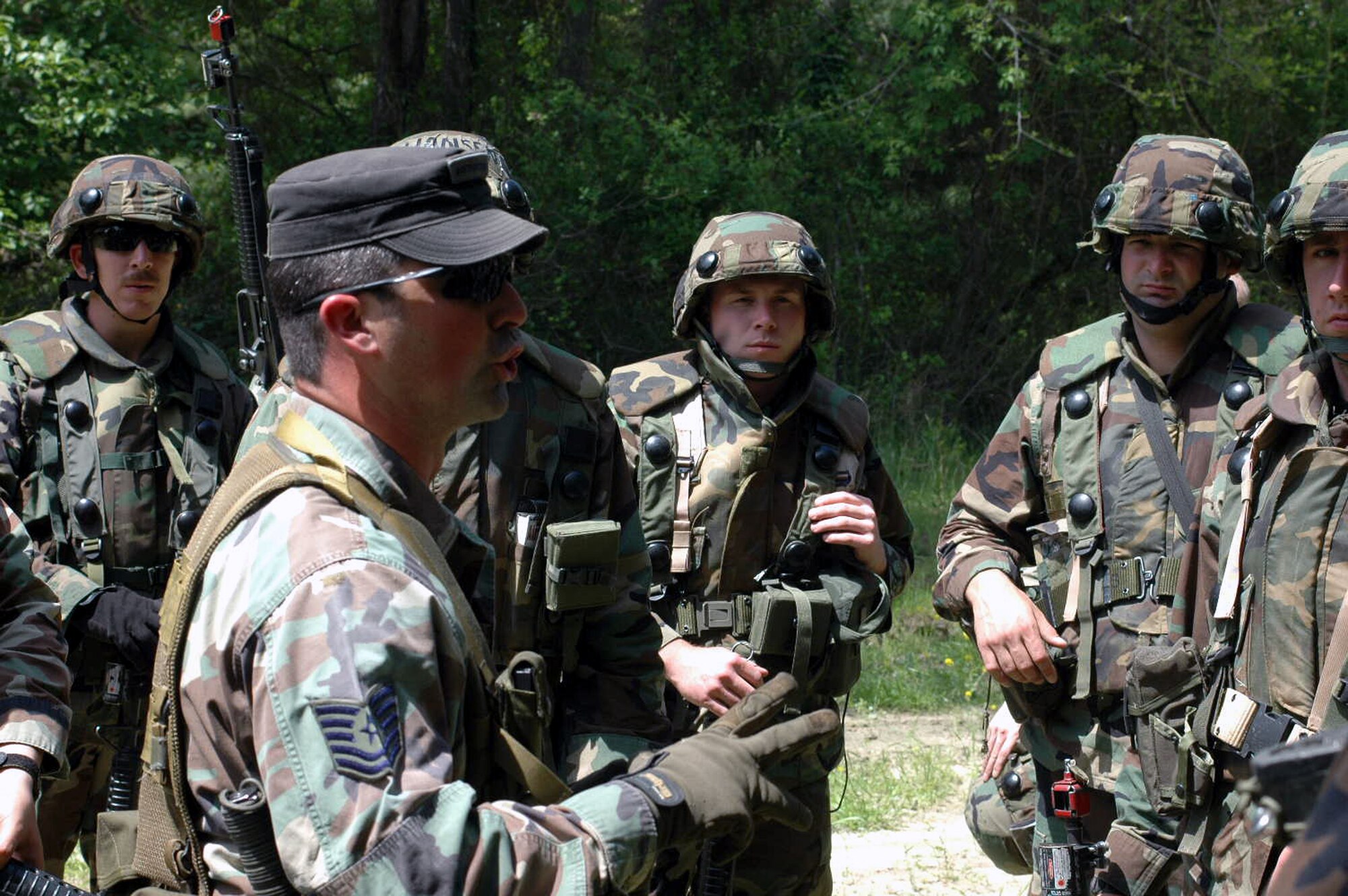 U.S. Air Force Tech. Sgt. Sean Graves, contingency skills training instructor, 421st Combat Training Squadron, U.S. Air Force Expeditionary Center, Fort Dix, N.J., talks to students in the Advanced Contingency Skills Training Course 07-2 about tactics and patrolling procedures during a class session on a Fort Dix range May 14, 2007.  The course prepares Air Force Airmen for upcoming deployments.  (U.S. Air Force Photo by Tech. Sgt. Scott T. Sturkol)