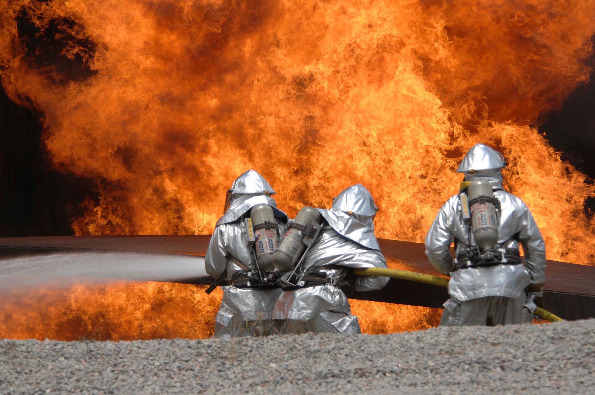 SHAW AIR FORCE BASE, S.C. -- Members of the 20th Civil Engineer Squadron Fire Protection Flight extinguish as part of the field training exercise May 23. The FTX is a specialized four-day training, mandatory requirement for all U.S. Air Force Civil Engineer Squadrons. The 20th CES trained in self-aid buddy care, cardiopulmonary resuscitation, weapons safety, decontamination, security, land navigation, night operations and any job-specific training required.  (U.S. Air Force photo by Airman First Class Kathrine McDowell)