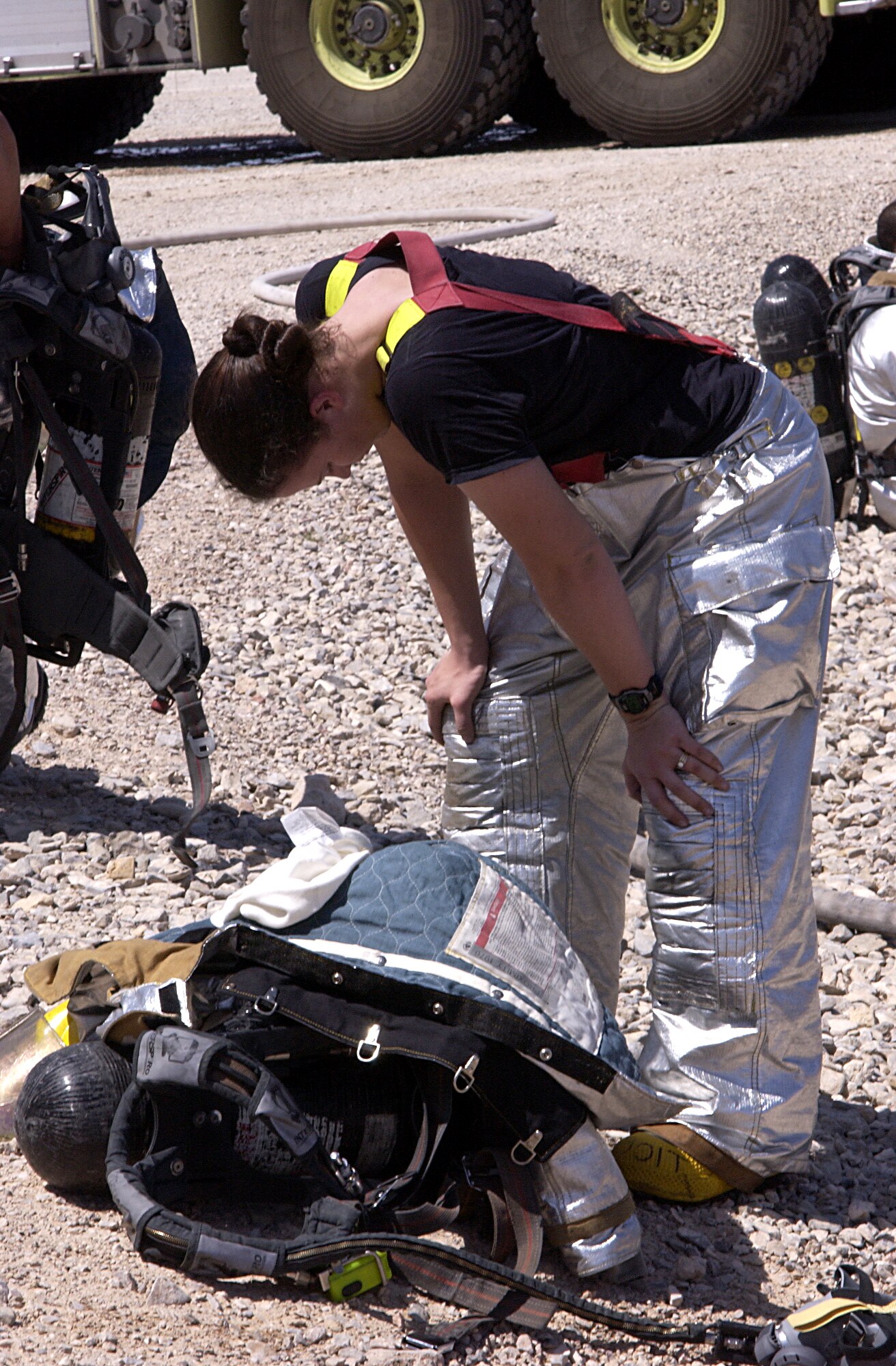 Airman 1st Class Cari Dudoit, firefigher with 99th Civil Engineer Squadron,  stands over her gear after participating in the joint exercise May 17,2007.  The exercise is designed to simulate an external and internal aircraft fire to prepare firefighters for the worst-case scenarion(U.S. Air Force photo/ Airman 1st Class Ryan Whitney)  