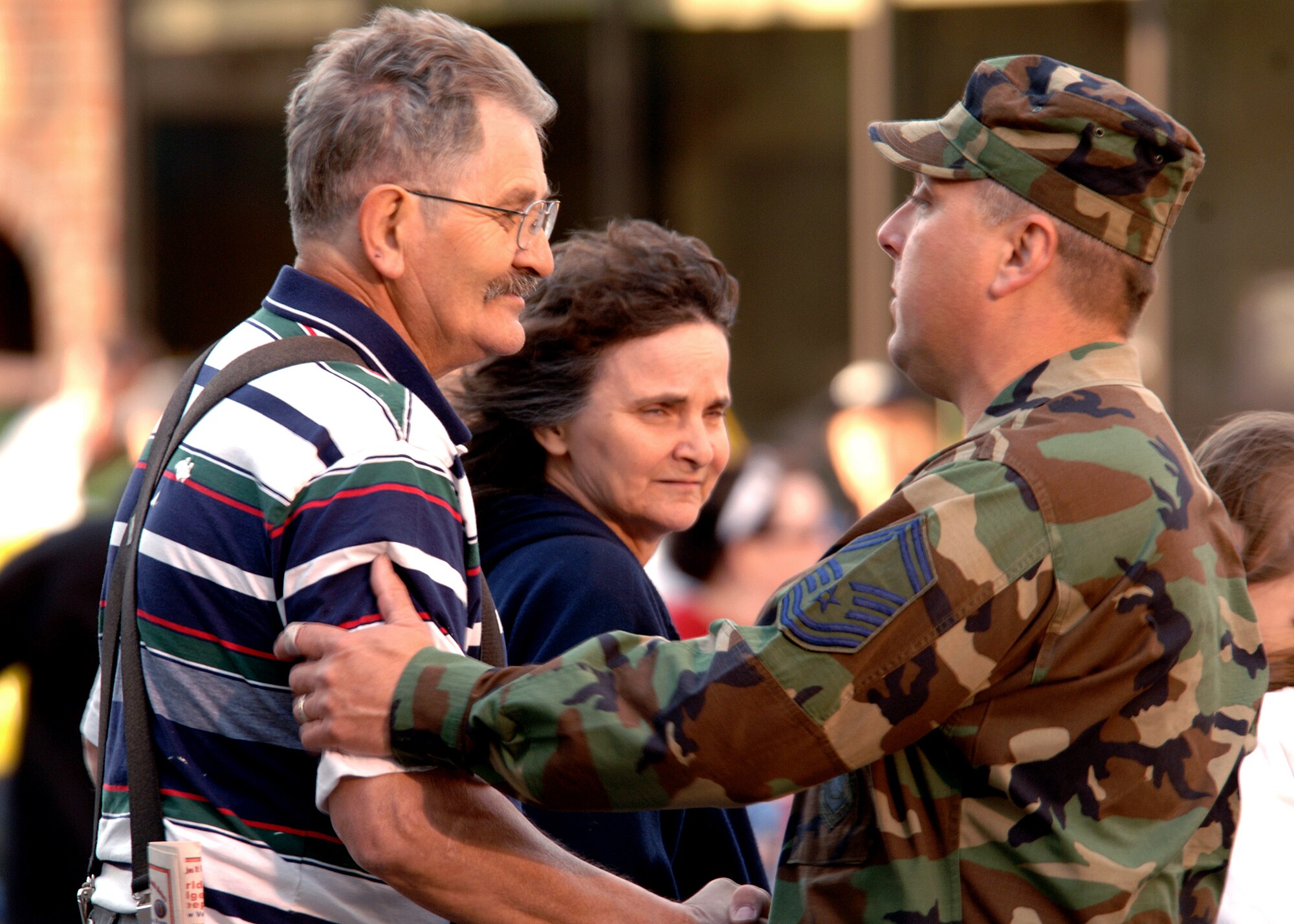 FAIRCHILD AIR FORCE BASE, Wash. – Senior Master Sgt. Robert Rose, 92nd Logistics Readiness Squadron, shakes hands with Ted Jansen, a Vietnam veteran, during the Lilac Festival Armed Forces Torchlight Parade in Spokane May 19. Mr. Jansen is a Vietnam veteran who lost his hearing while in the Navy because of the cannons on a destroyer. (U.S. Air Force photo/Airman 1st Class Joshua Chapman)