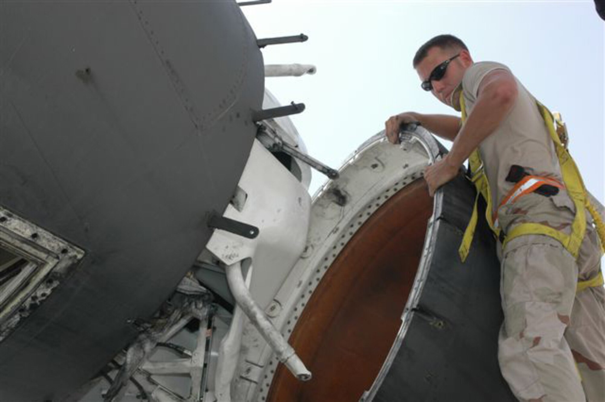 Senior Airman Thomas Dunlap, with the 379th Expeditionary Aircraft Maintenance Squadron, 34th Aircraft Maintenance Unit here, prepares to reinstall the radome on the back of a B-1B Lancer here. Airman Dunlap is deployed from the 28th Bomb Wing at Ellsworth Air Force Base, S.D. and is a native of Bellefontaine, Ohio.