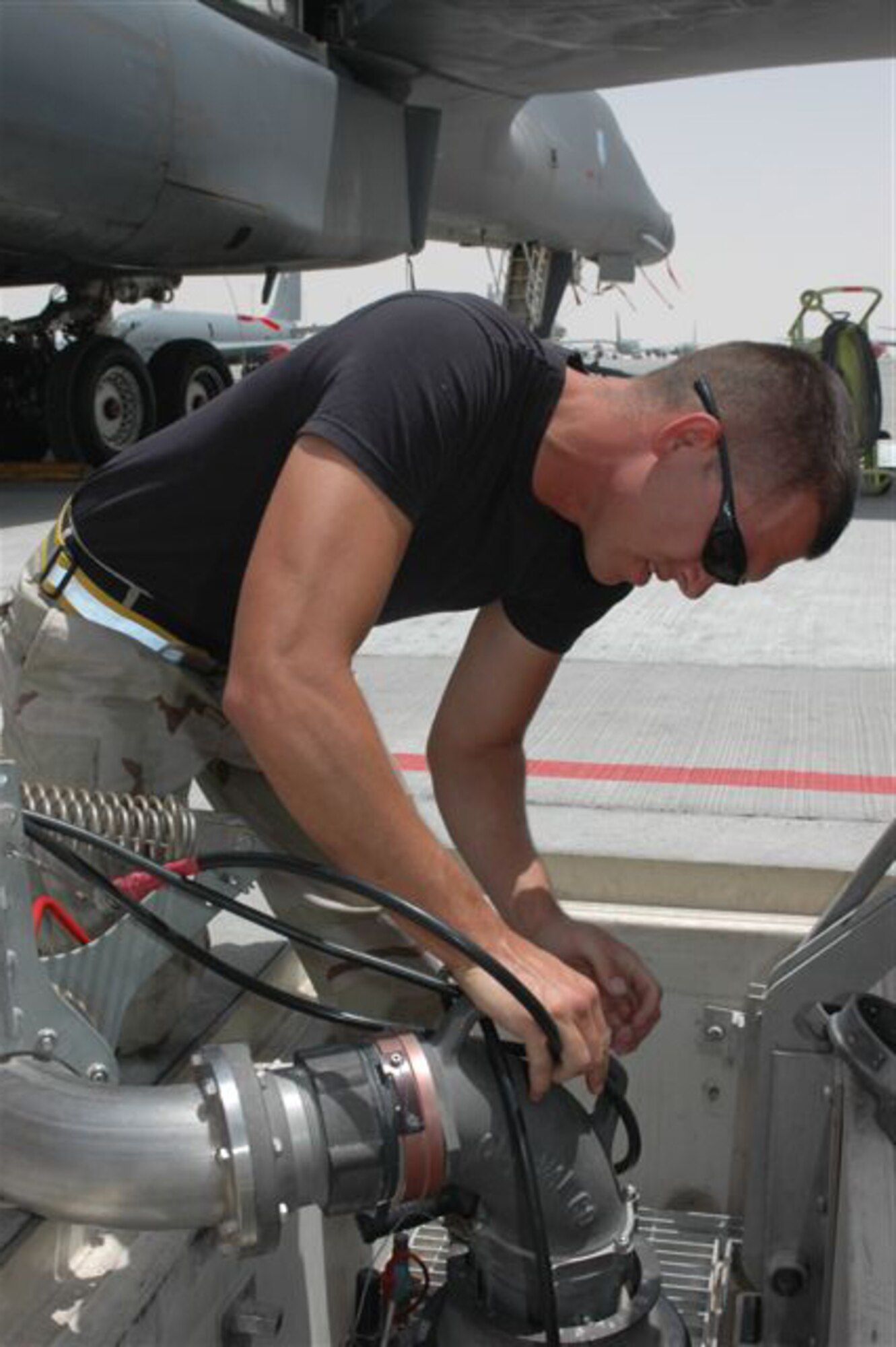 Staff Sgt. Jonathon Keck, with the 379th Expeditionary Aircraft Maintenance Squadron, 34th Aircraft Maintenance Unit here, prepares to fuel a B-1B Lancer by hooking up the gas hose to the ground. Sergeant Keck is deployed from the 28th Bomb Wing at Ellsworth Air Force Base, S.D. and is from San Antonio.   