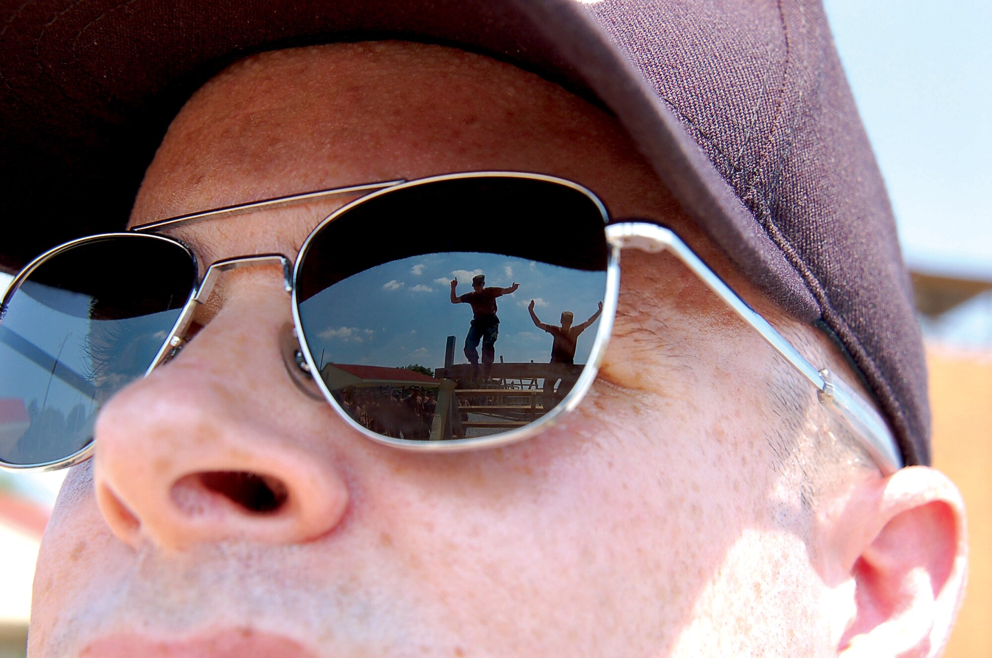Capt. Brian Herman, an ROTC instructor from the University of Hawaii, watches as cadets make their way over a balancing obstacle during summer field training at Maxwell Air Force Base, Ala., in 2006. This year ROTC cadre staff expect to train more than 1,250 cadets during summer field training at Maxwell. An additional 1,250 cadets will be trained at Ellsworth Air Force Base, S.D. (U.S. Air Force photo/Tech. Sgt. Scott Moorman) 