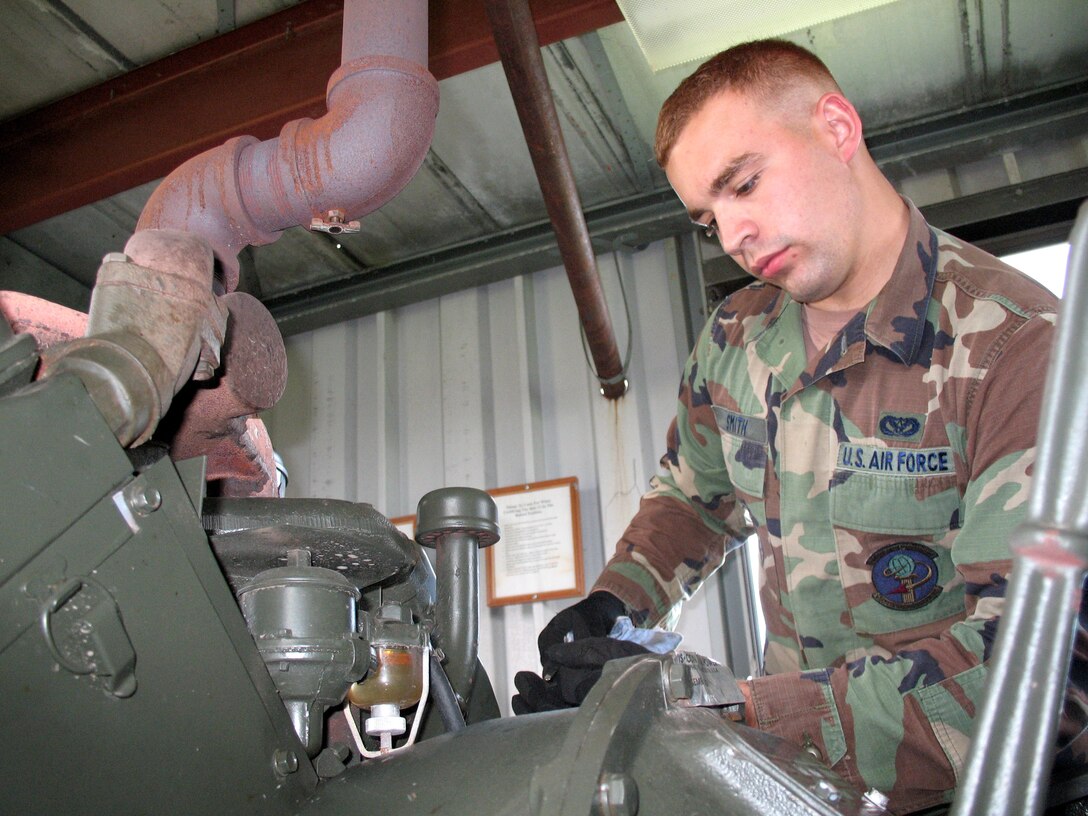 Senior Airman Wade Smith checks the oil in the generator that runs the barrier arresting kit May 18 at Lajes Field, Azores. Civil engineering Airmen from Lajes Field's power production shop stand to stop aircraft with brake and engine failures. (U.S. Air Force photo/Airman 1st Class Shannon Ofiara)