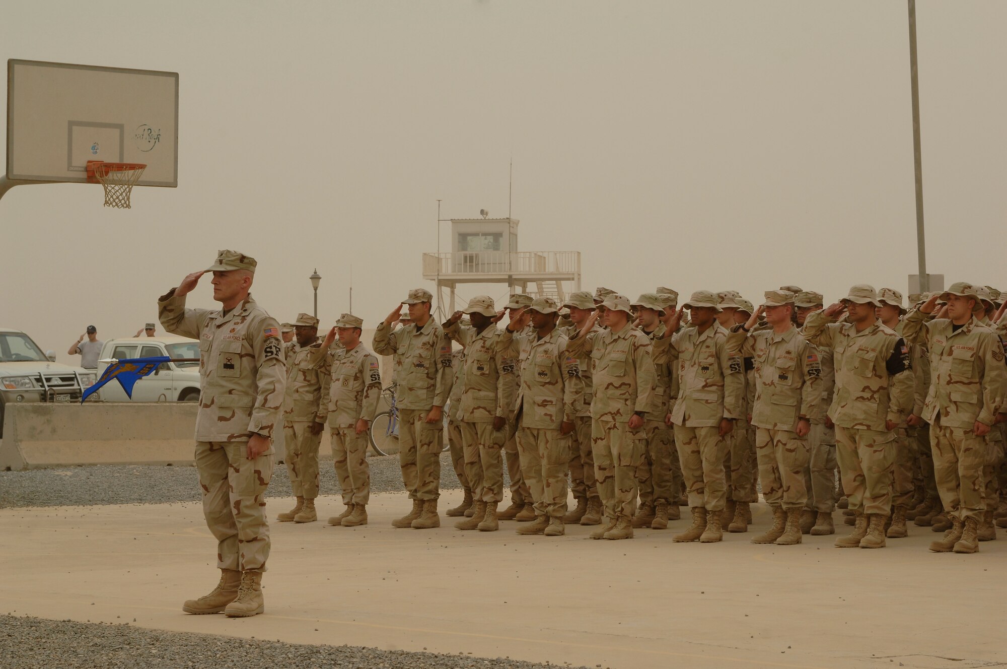Lt. Col. David Marttala, 386th Expeditionary Security Forces Squadron Commander, leads his squadron in a salute during a memorial retreat May 18, 2007. Security forces Airmen performed the ceremony in honor of National Police Week. The 386th ESFS also paid a special tribute to Staff Sgt. John Self, a security forces dog handler killed in action May 14. (U.S. Air Force photo by Staff Sgt. Raymond Mills)