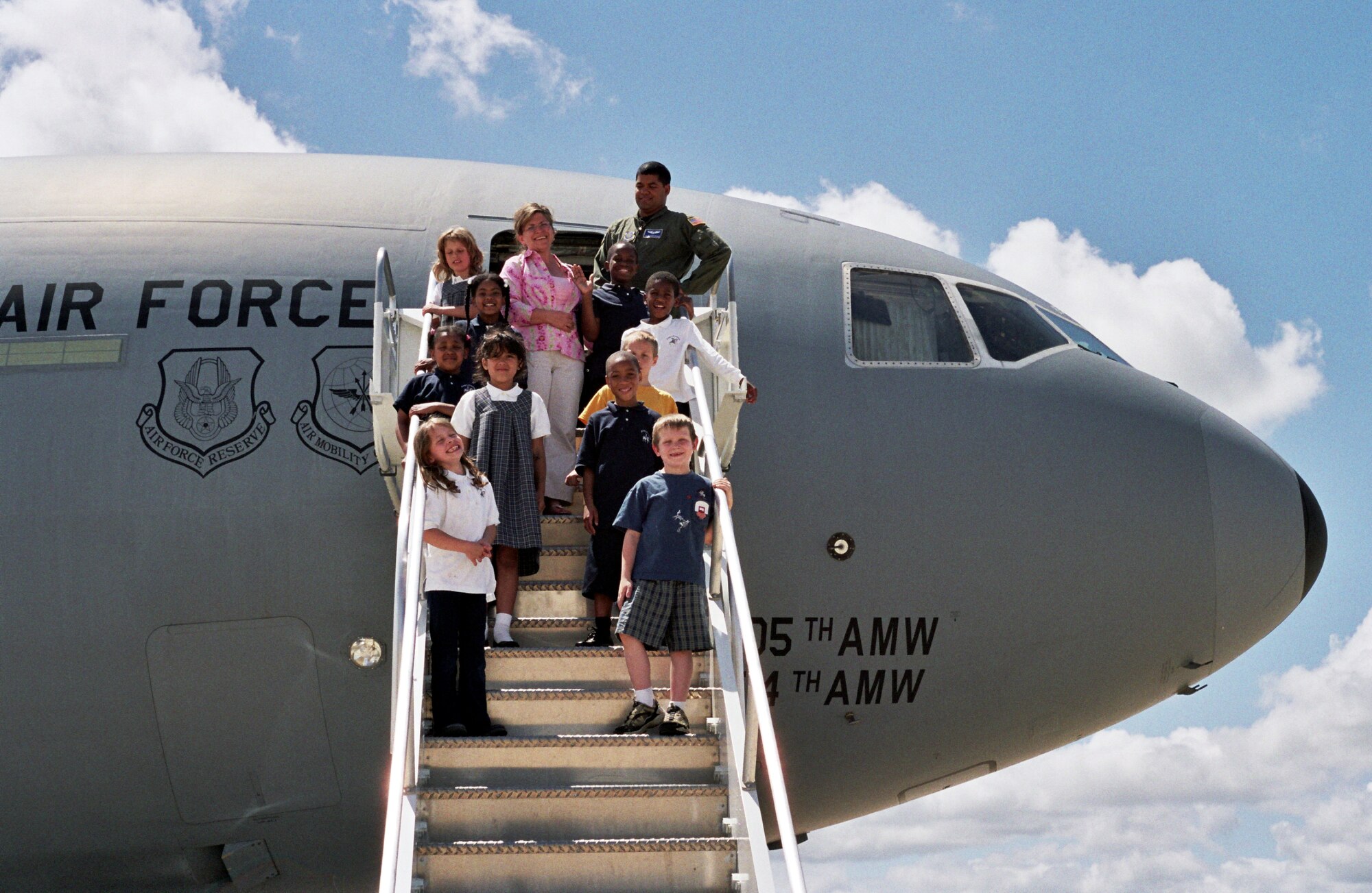 Left, Susan Maynard, King's Academy second grade teacher, Senior Airman Alex Maynard, 32nd Air Refueling Squadron flight engineer, and Mrs. Maynard's second grade class tour a KC-10 here recently. The class learned about the KC-10s mission, the aircraft parts and what they do, and saw the boom and how it refuels. King's Academy is located outside of McGuire AFB, and seven of the 10 students are from military families.