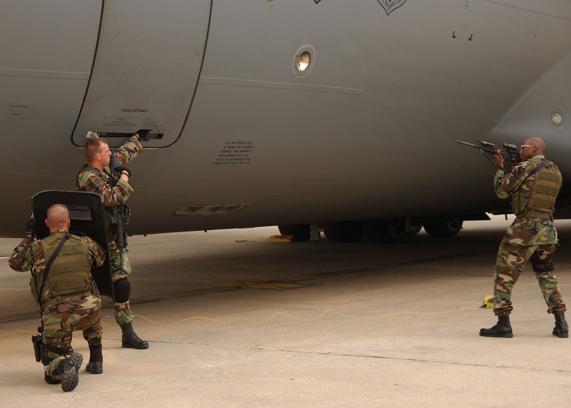Tech. Sgt. Cliff Sowder, Senior Airman Jeffrey Peppeard and Airman 1st Class Chip Perkins, 39th Security Forces Squadron Emergency Services Team members, prepare to storm a C-17 during a recapture demonstration May 18. The 39th SFS exercised response capabilities for both vehicle and aircraft response scenarios for Brig. Gen. Mary Kay Hertog, Air Force Security Forces director, May 17-19, as she toured Incirlik Air Base.  (U.S. Air Force photo by Technical Sergeant Patrick Hyde)