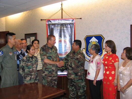 Lt. Col. William Toguchi, 72nd Air Base Wing chaplain and Asian Pacific American Heritage advisor, led APAH committee members in extending their appreciation for Col. Michael Niezgoda’s support in providing them two excess flag poles for use in mounting their banners, one of which is displayed in the background. Col Niezgoda, 38th Engineering Installation Group commander, was given an APAH coin as a token of their appreciation.


