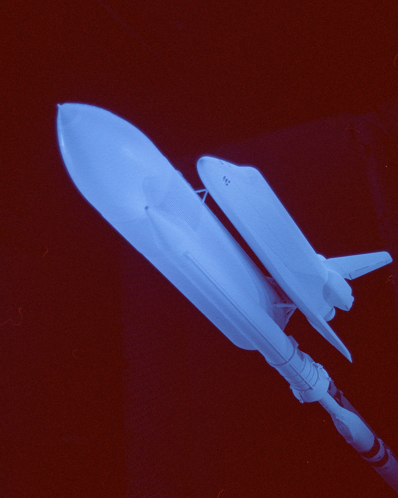 A “blue light” photo of the “full stack” space shuttle model in 16-foot transonic wind tunnel at the Air Force’s Arnold Engineering Development Center.