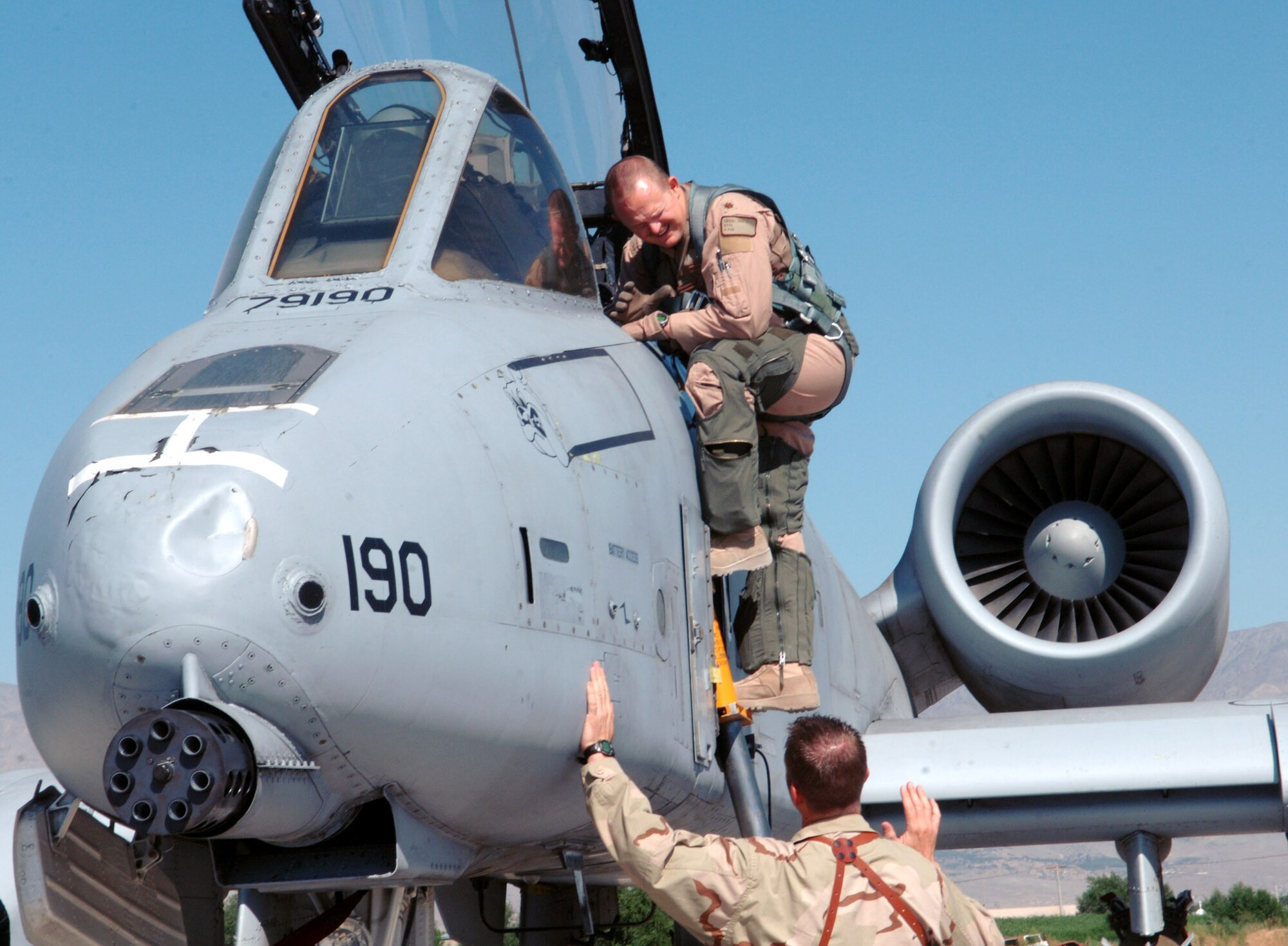 Maj. Troy "Cabbage" Owens (above), 354th Expeditionary Fighter Squadron A-10 pilot, speaks with Capt. Kevin Koren, 354th Expeditionary Aircraft Maintenance Squadron officer in charge, prior to his flight at Bagram Airfield, Afghanistan May 23. Maj. Owens and Capt. Koren are deployed from Davis-Monthan Air Force Base, Ariz. (photo by Staff Sgt. Craig Seals) 