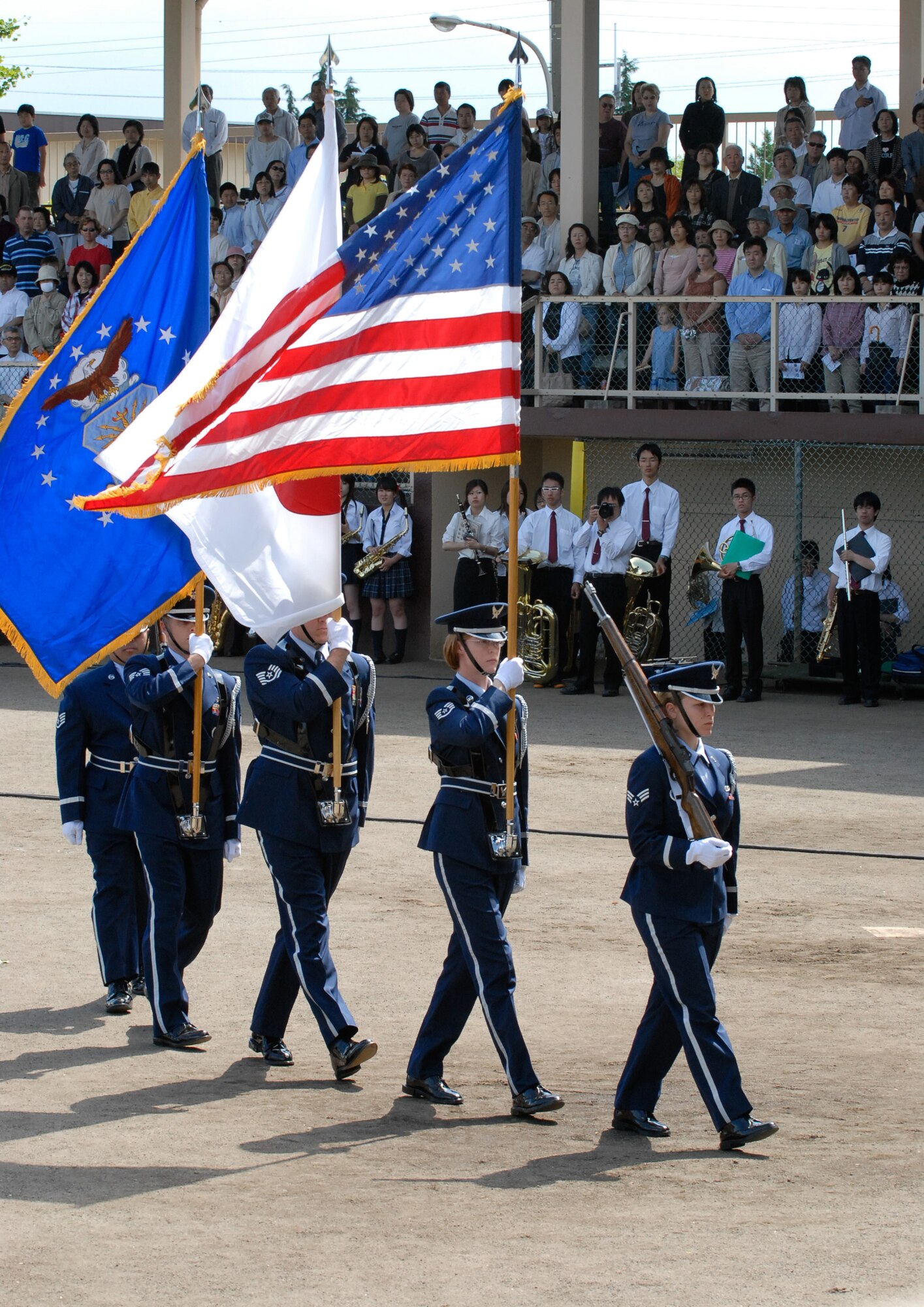 Members of Yokota's Honor Guard March the Flags on to the field during the PACAF Band's Sayonara concert. PACAF Band will be reduced to 11 members due to realignments within the Air Force. (Photo by Master Sgt. Nelson James VIRIN 070520-F-8509J-017