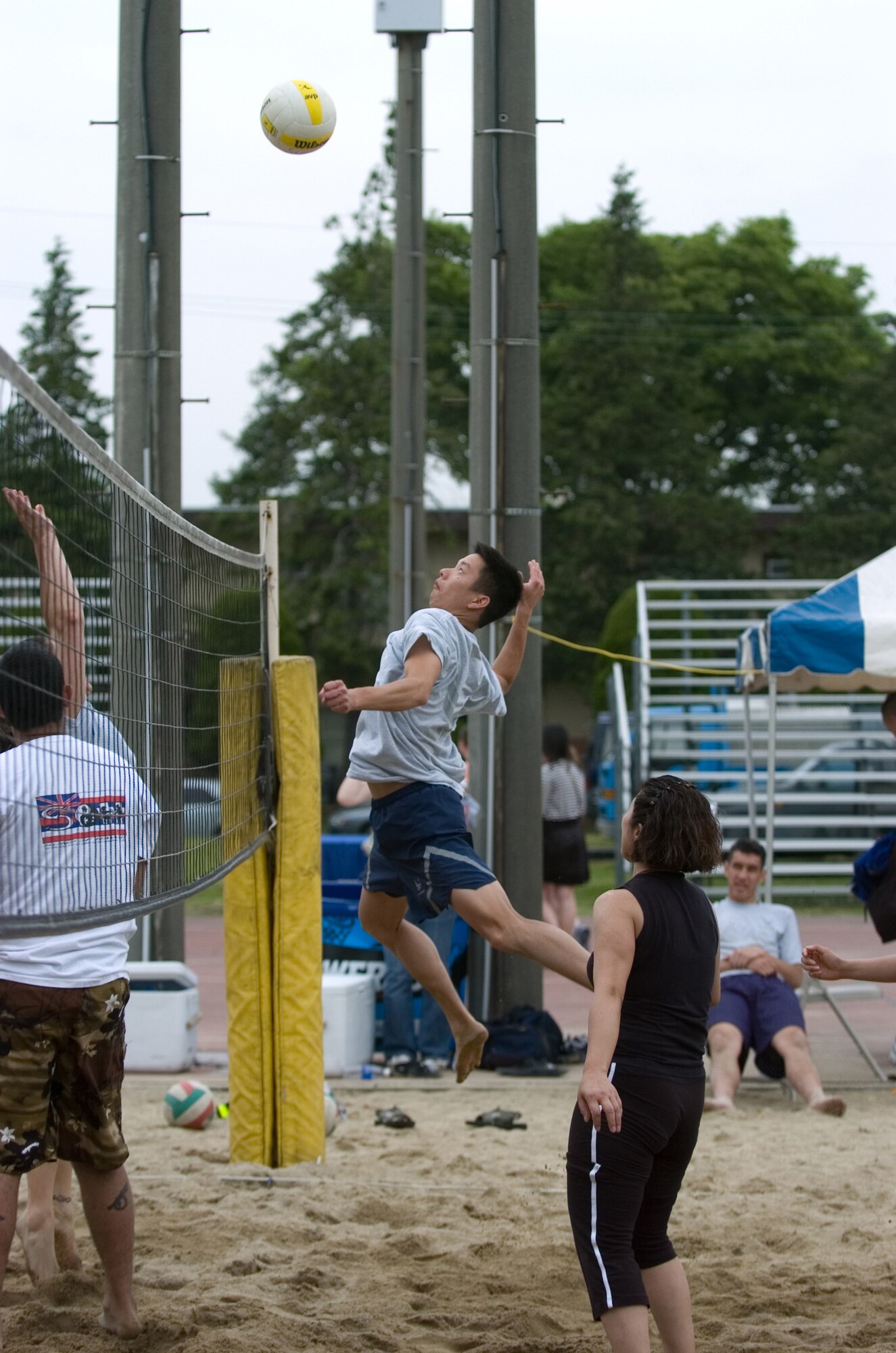 Ryan Wong spikes a volleyball during a tournament.(U.S. Air Force photo by Master Sgt. Nelson James VIRIN 070518-F-5809J-136)