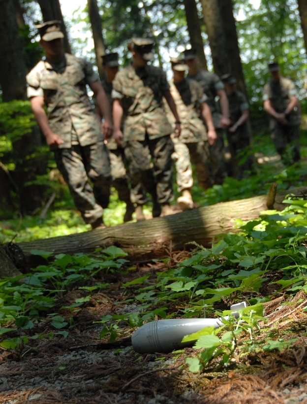 Marines with Combined Arms Training Center Camp Fuji move through a simulated improvised explosive device lane on the Jiggs Fitness Trail during a corporals course May 21 through June 1.
