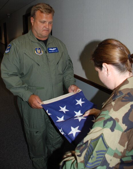 932nd Honor Guard members prepare the American Flag for the Memorial Day parade in Illinois.