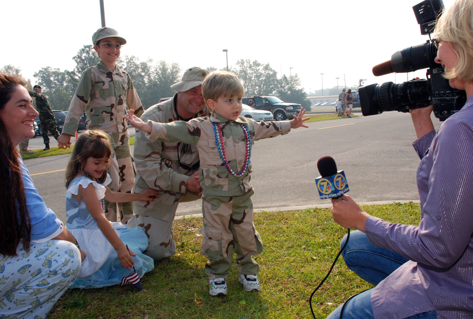 Ian Bowden, 2, spreads his hands as wide as he can to illustrate to a local news reporter how big the fish his dad, Maj. Cooper Bowden, is going to catch on their upcoming fishing trip during a homecoming celebration May 24 at Eglin Air Force Base, Fla. Family members gathered at Eglin AFB to welcome home more than 175 members of the 728th Air Control Squadron from a deployment in support of Operation Iraqi Freedom. (U.S. Air Force photo/Staff Sgt. Mike Meares)