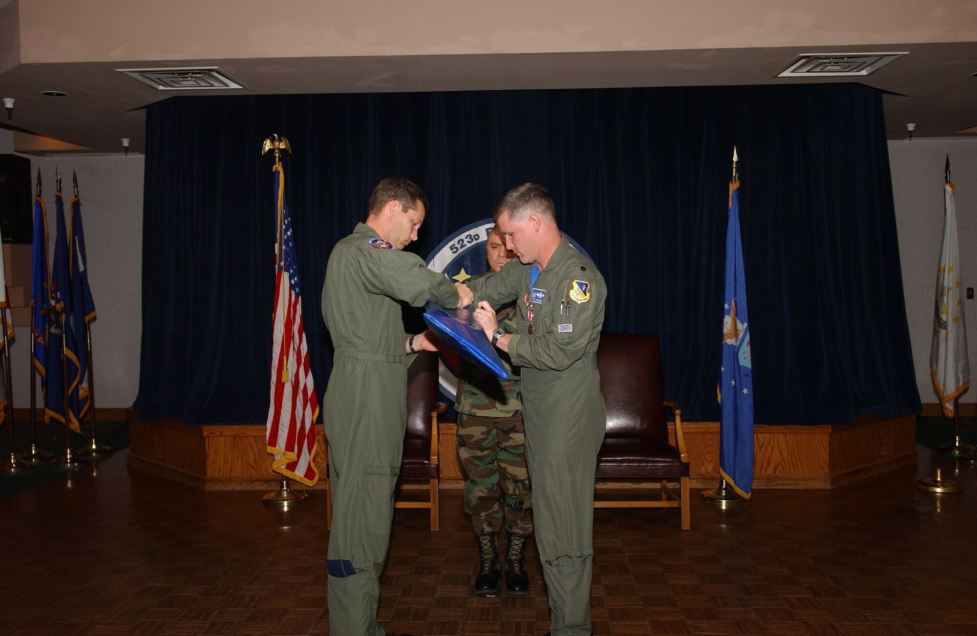CANNON AIR FORCE BASE, N.M. -- Col. Jeff McDaniels (left), 27th Operations Group commander, and Lt. Col Brad Kearney, 523rd Fighter Squadron commander, furl the 523 colors during an inactivation ceremony on May 23. (U.S. Air Force photo by Tech. Sgt. Scott Mackay)
