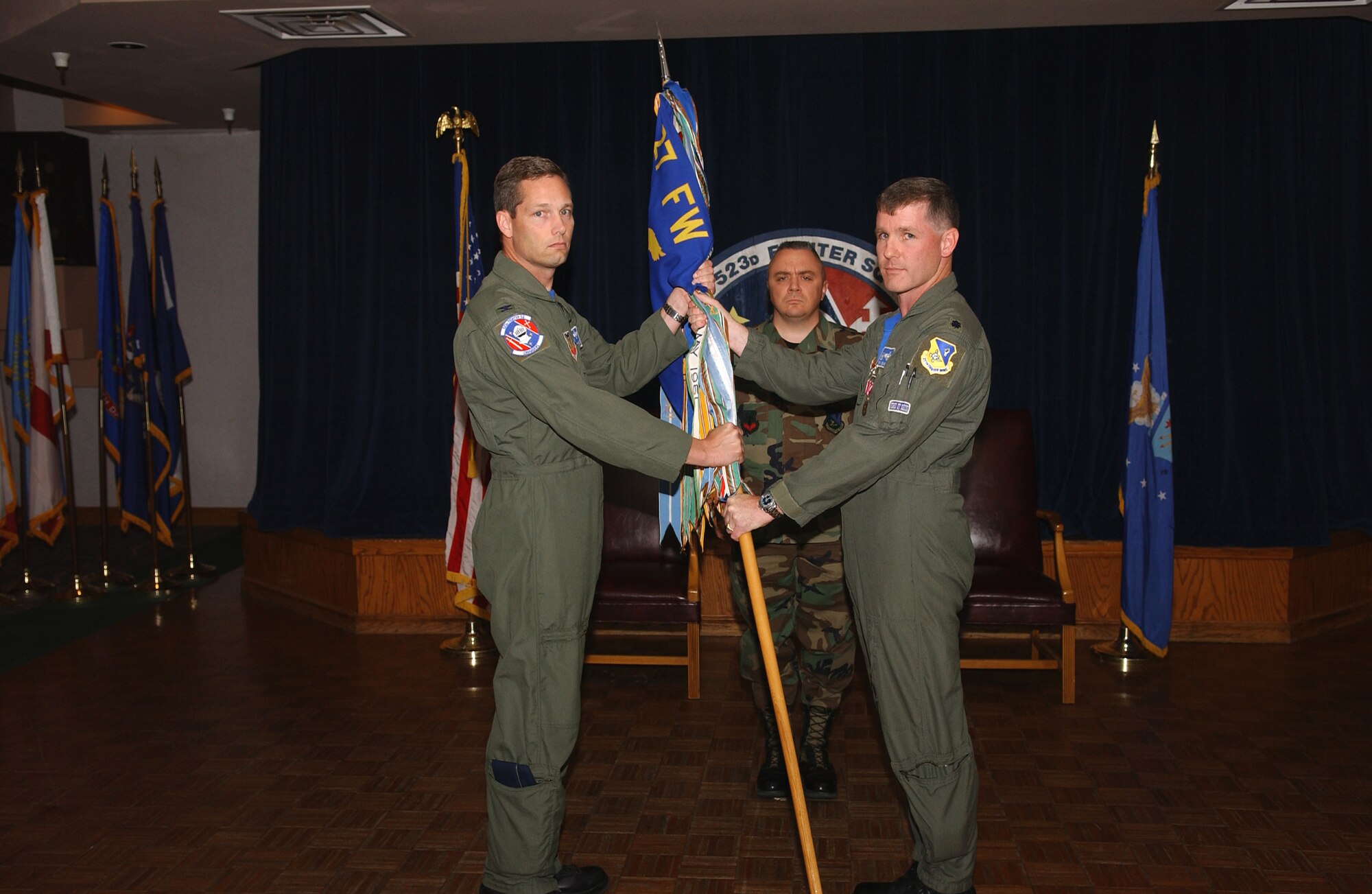 CANNON AIR FORCE BASE, N.M. -- Col. Jeff McDaniels, 27th Operations Group commander, receives the guidon from Lt. Col. Brad Kearney, 523rd Fighter Squadron commander, shortly before the squadron's  inactivation in a ceremony on May 23. (U.S. Air Force photo by Tech. Sgt. Scott Mackay)